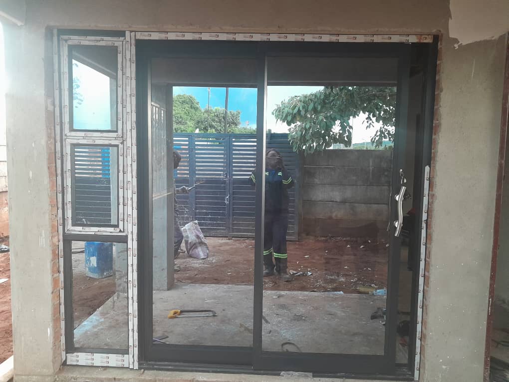 Aluminium sliding glass door with sidelight installed on site