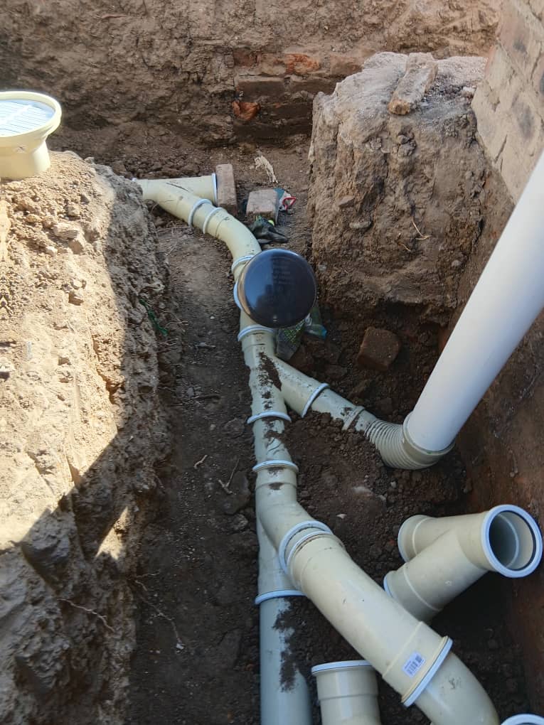 Plumbing — underground drainage pipe network laid in excavated trench