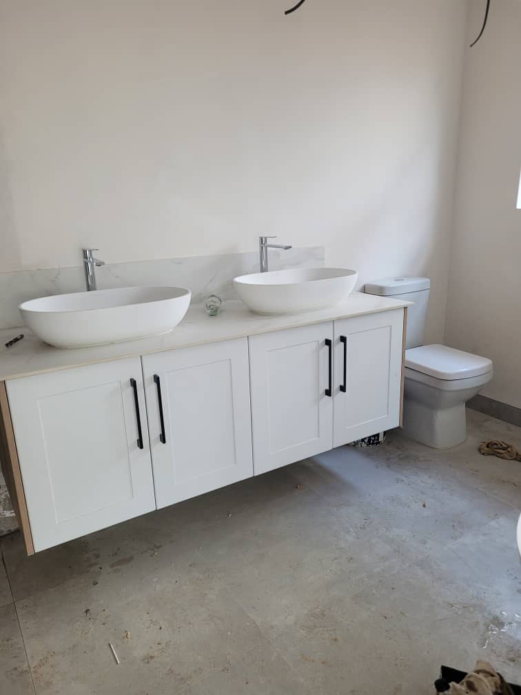 Bathroom — double vessel sinks on floating white vanity with marble countertop