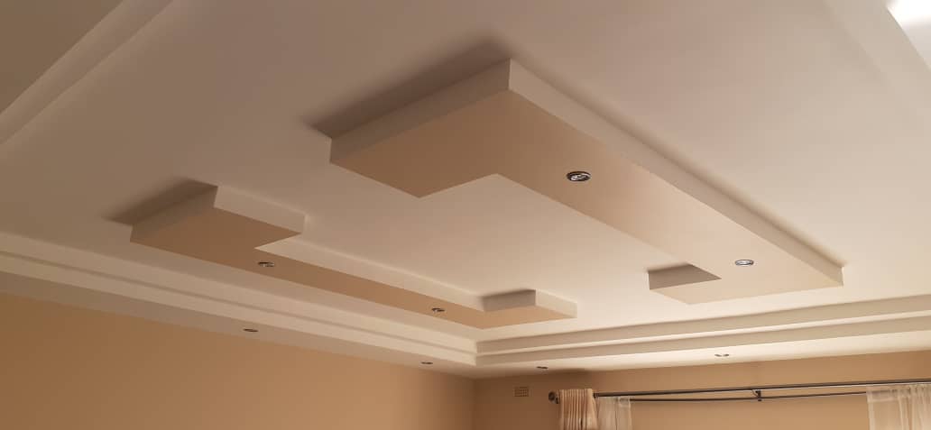 Suspended ceiling — ornate multi-level plaster ceiling with recessed downlights