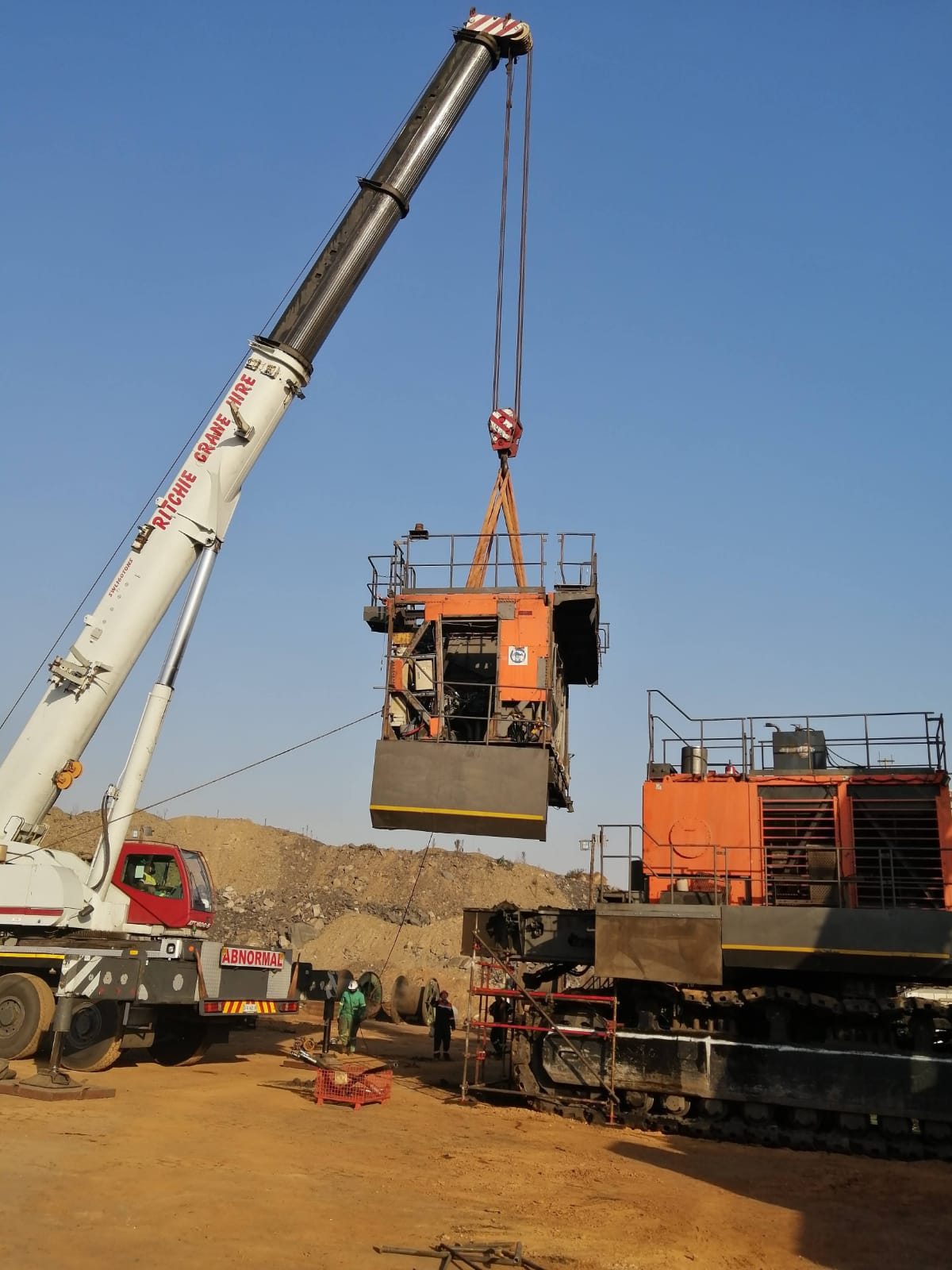 Ritchie crane hire lifting a mining machine component during a rigging operation