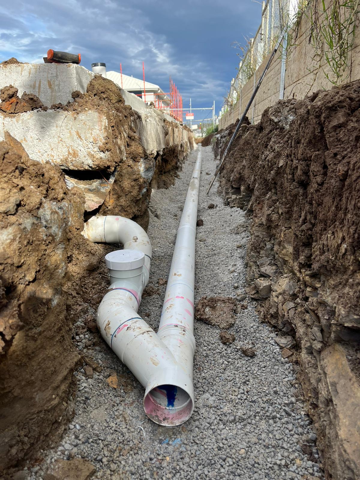 Excavated trench with PVC sewer pipe installation