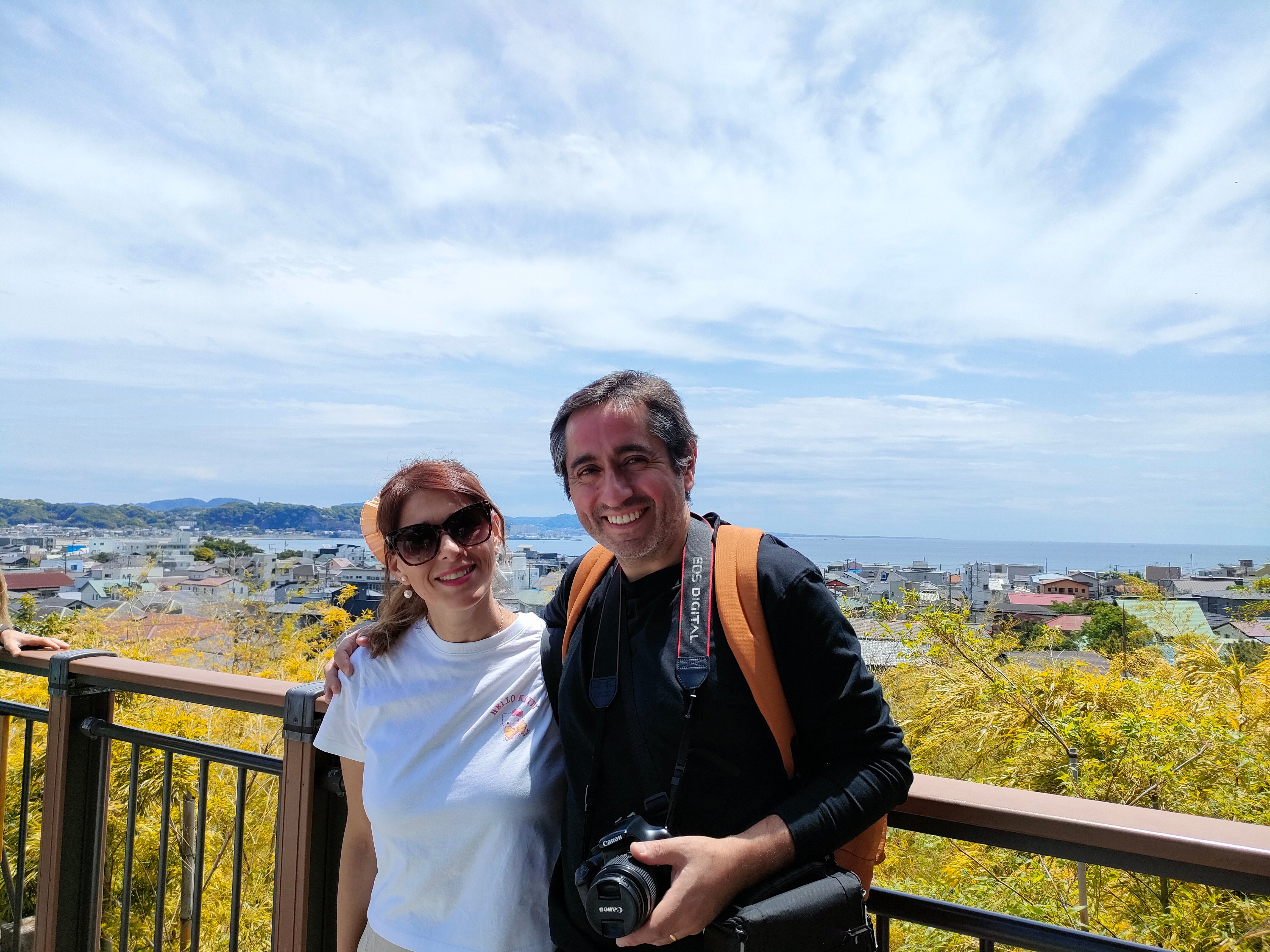 Couple enjoying the panoramic view of Kamakura cityscape and ocean from Hase-dera temple observation deck
