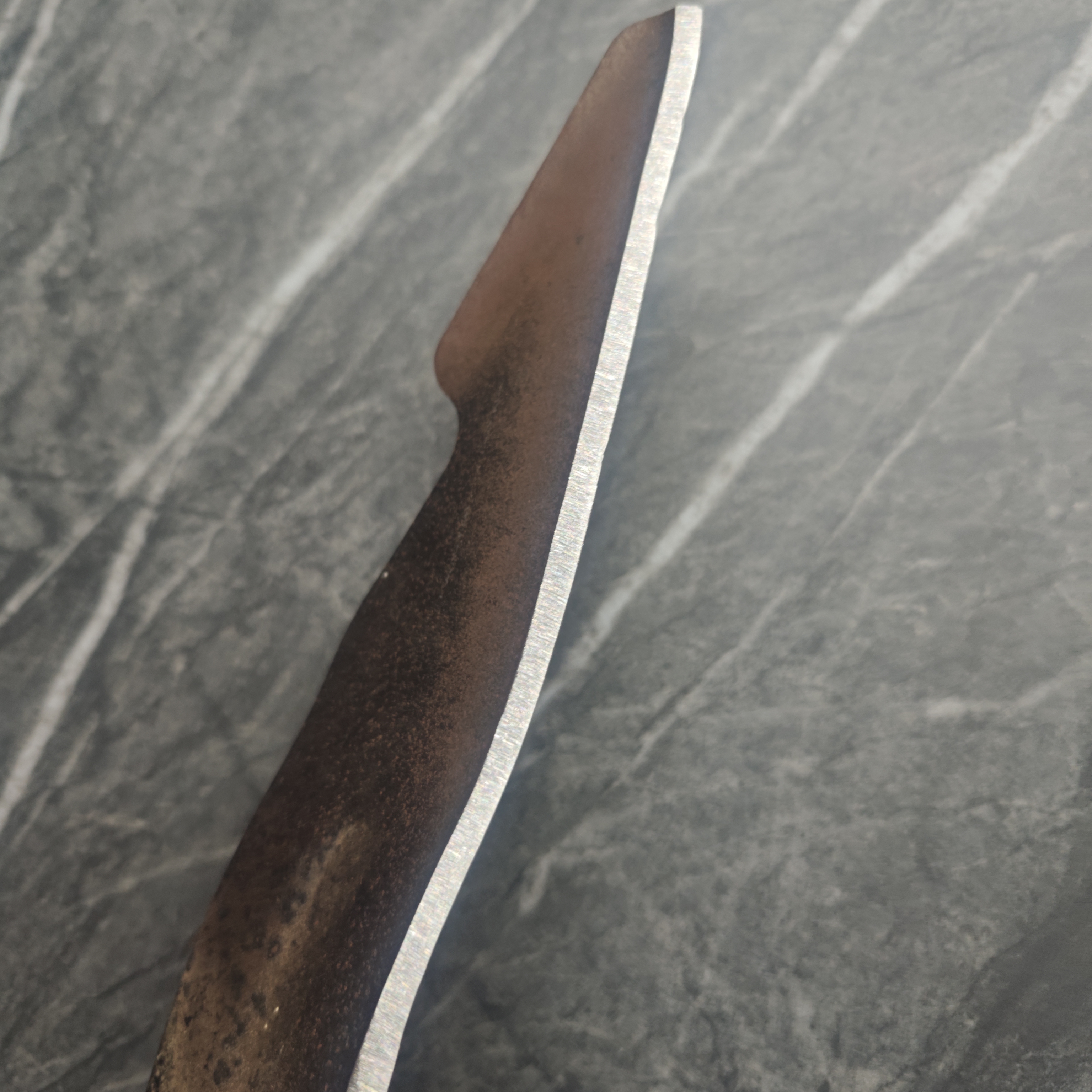 Mower blade after sharpening — clean, restored edge
