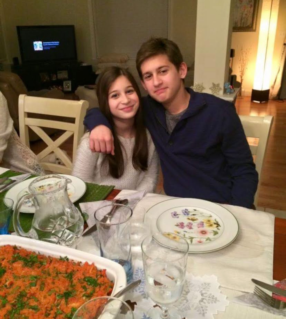 Alex and sister at dinner table