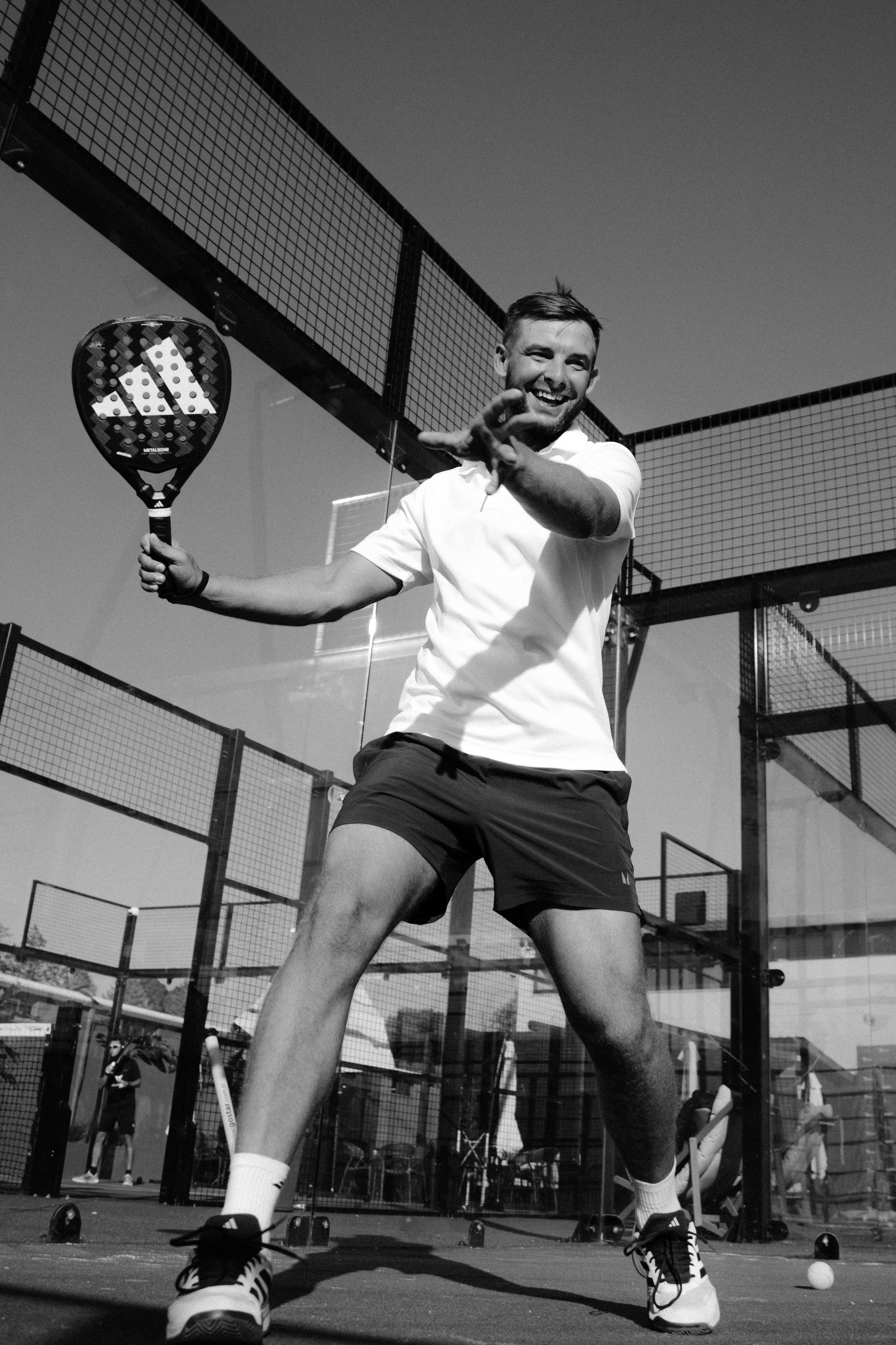 Padel coach in action on court