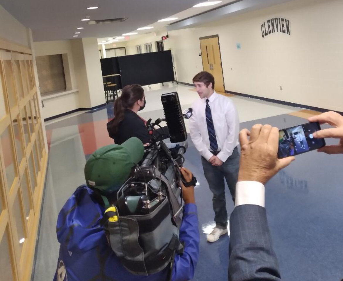 Alex being interviewed by news media