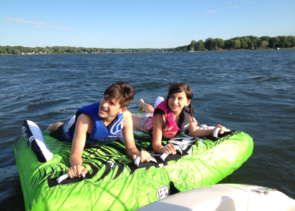 Alex and sister on lake tube