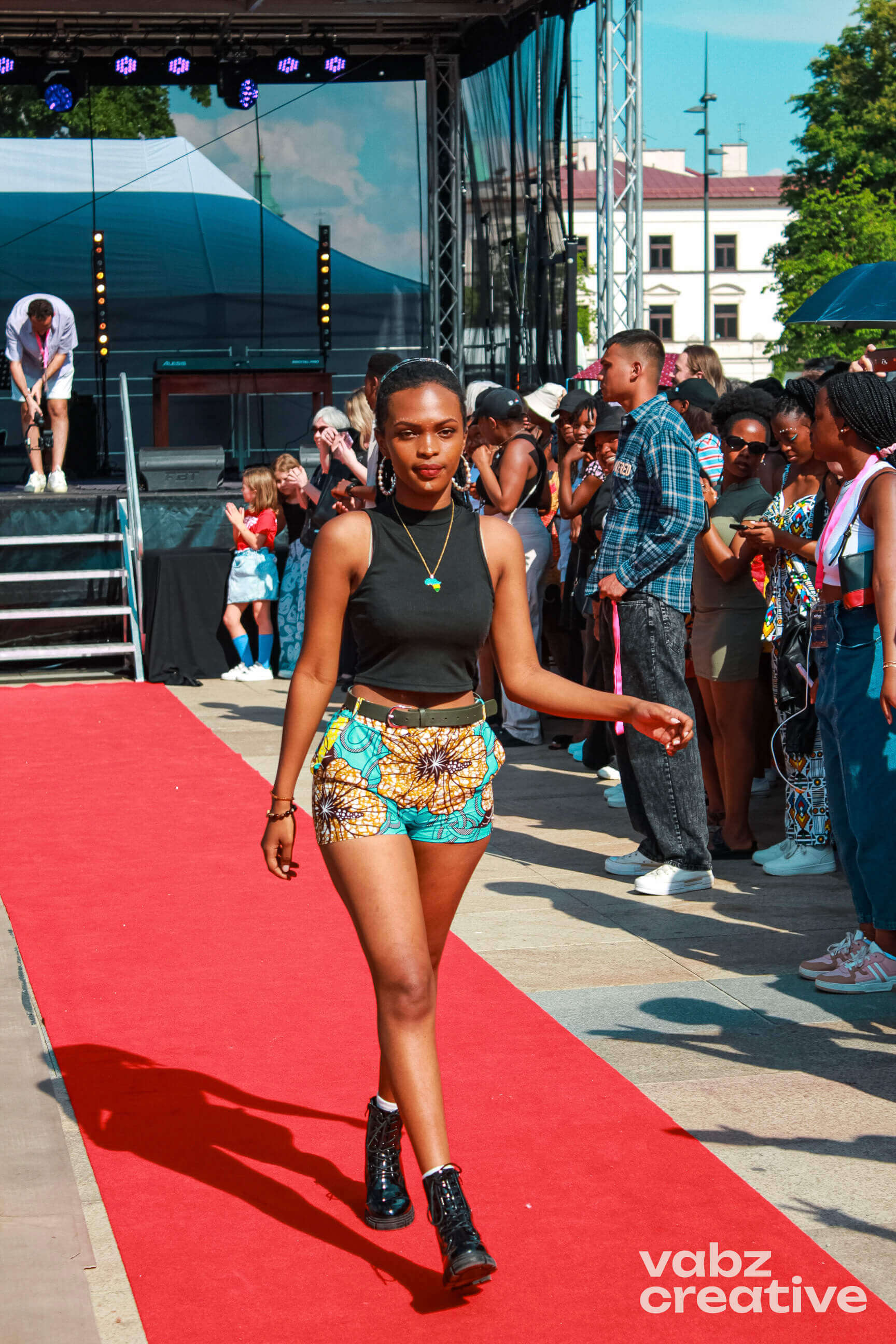 Woman in crop top and patterned shorts