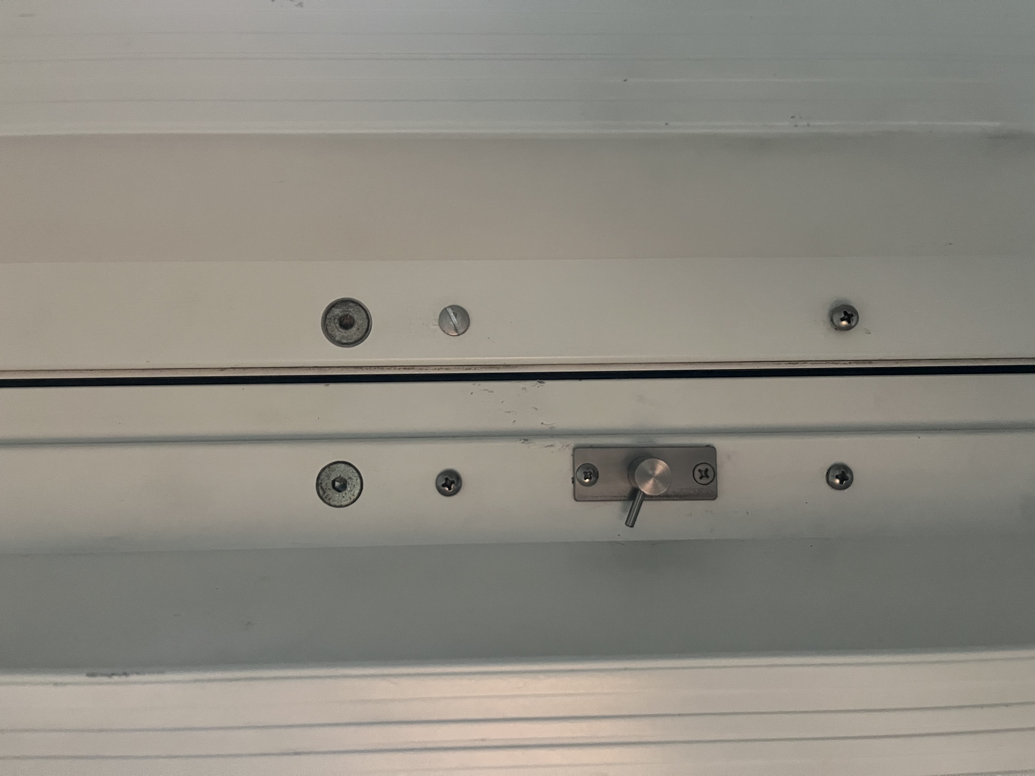 After: new satin nickel slide bolt lock cleanly installed on balcony sliding glass door frame