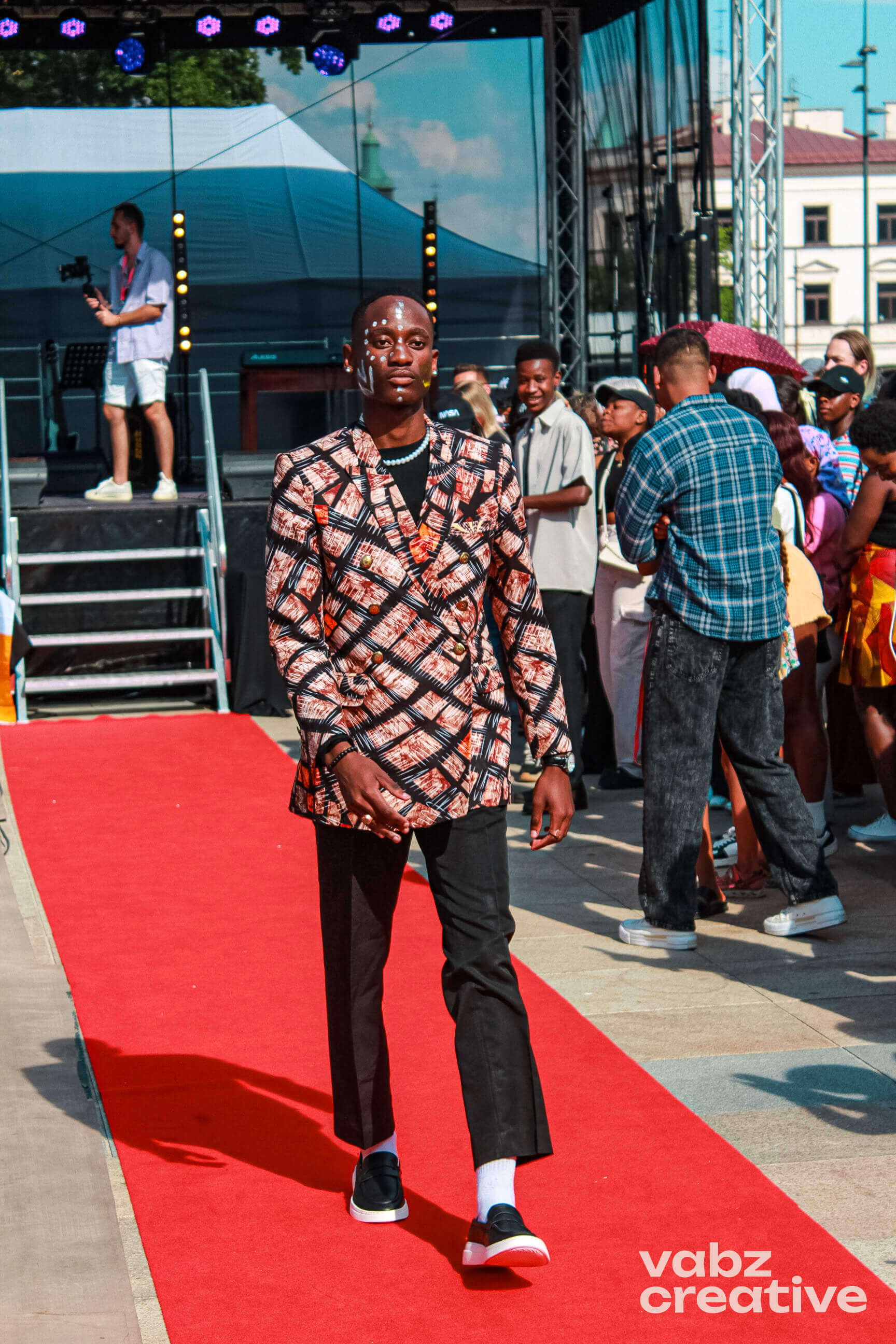 Man in patterned blazer on runway