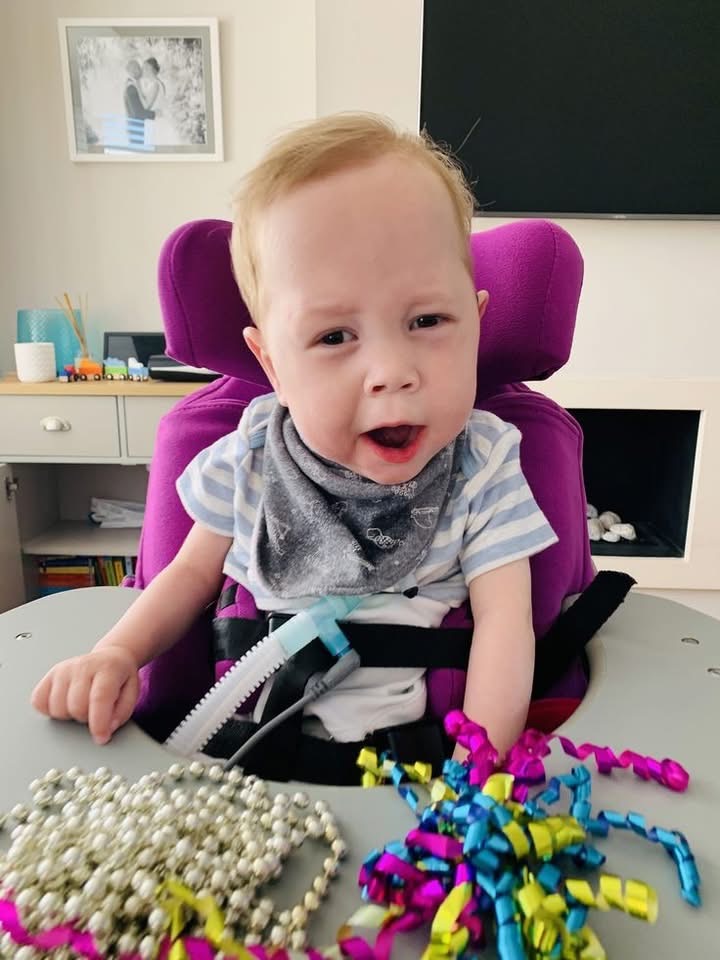 Child participating in sensory activities with colorful materials