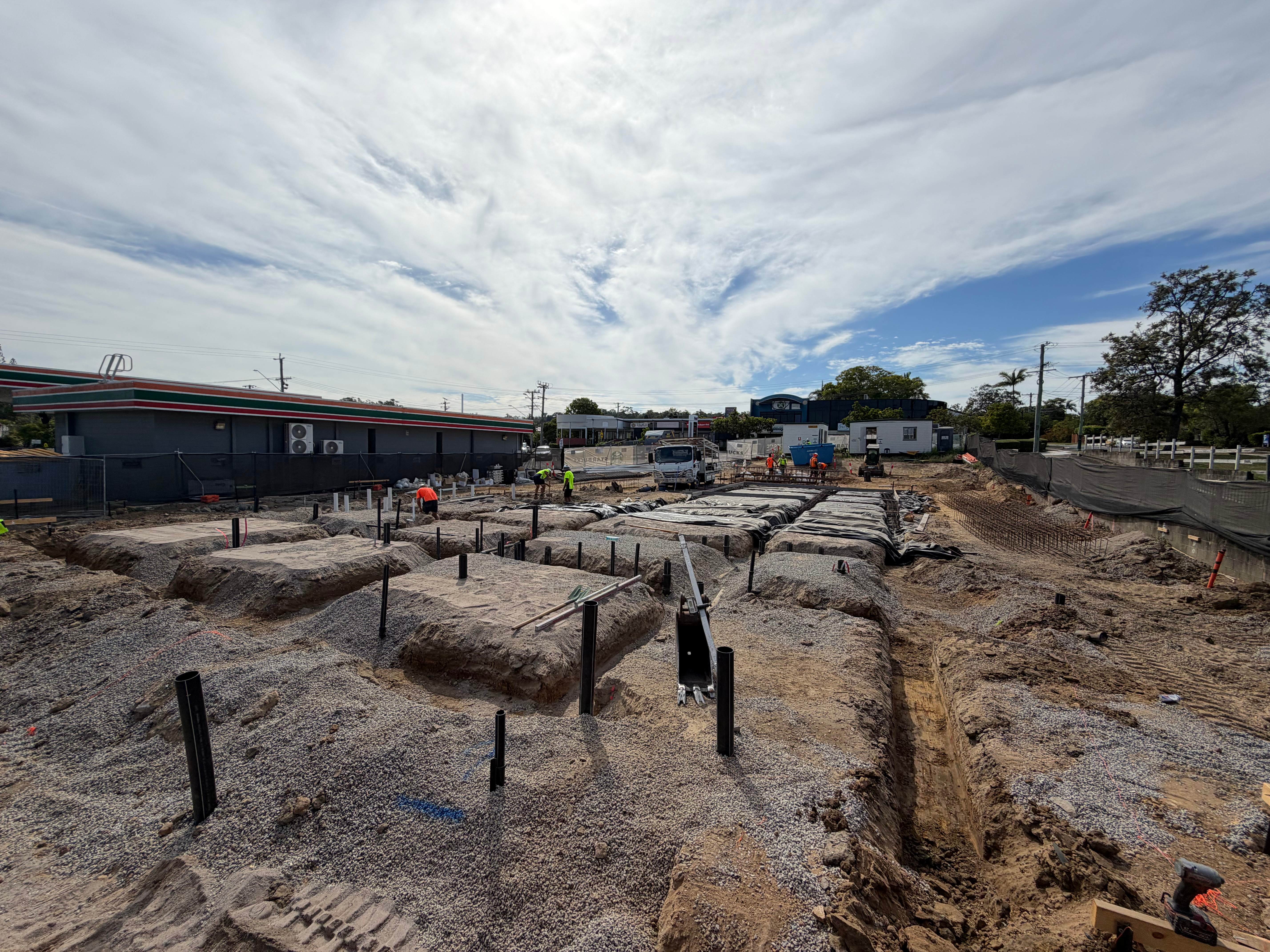 Commercial civil construction site with foundation preparation and pier holes