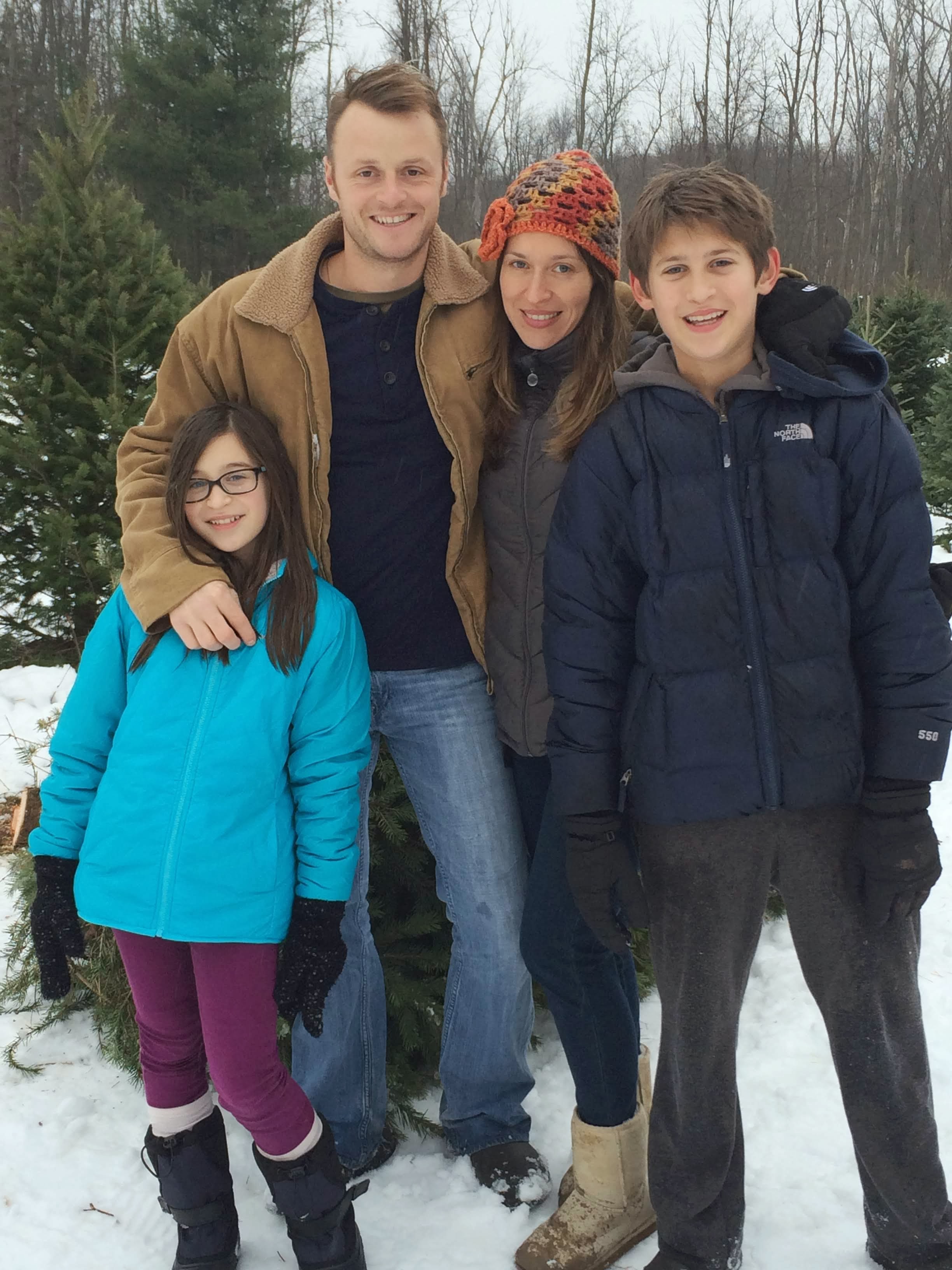Winter family photo with Alex, parents, and sister