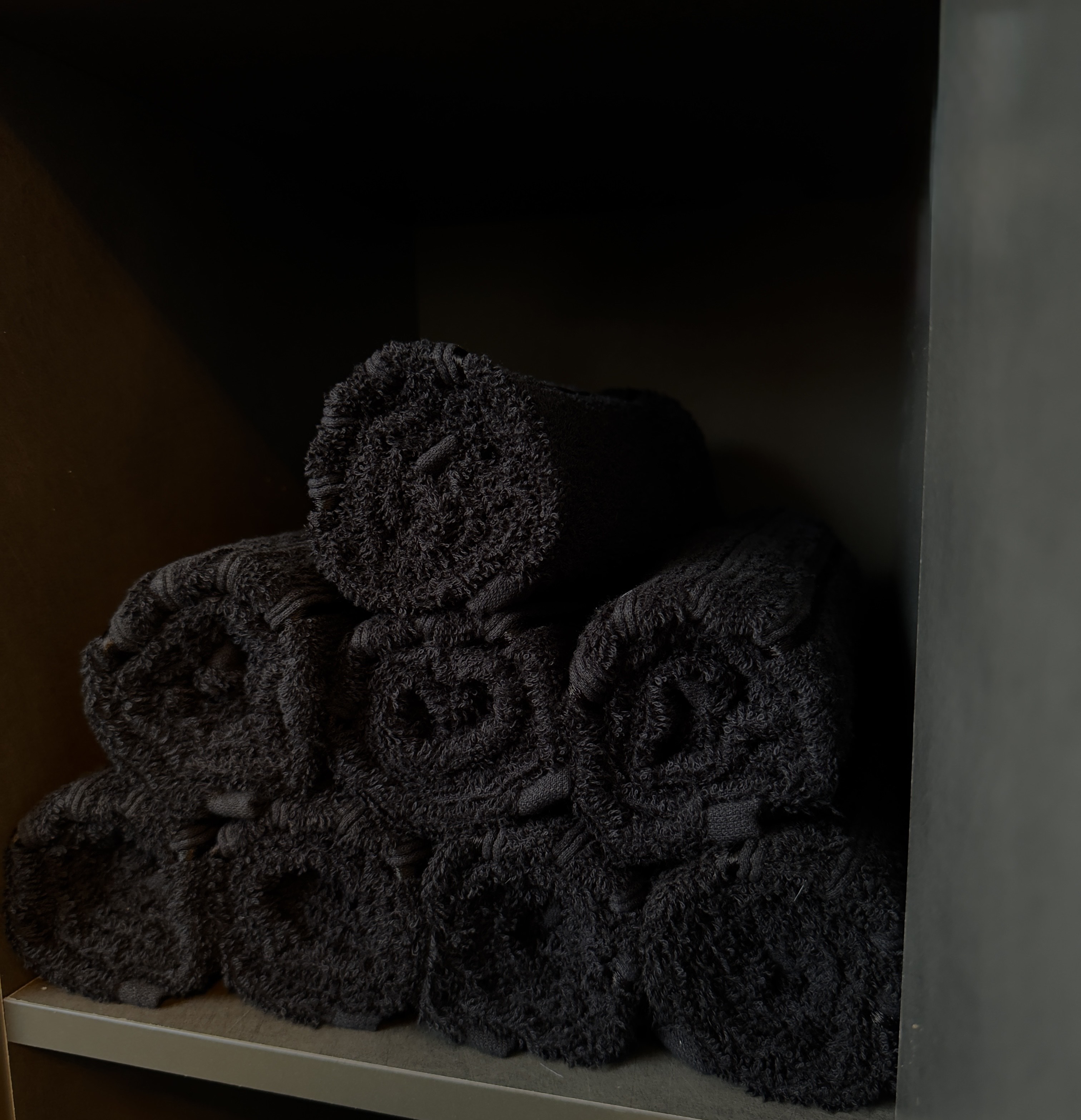 Luxurious black towels prepared for your treatment