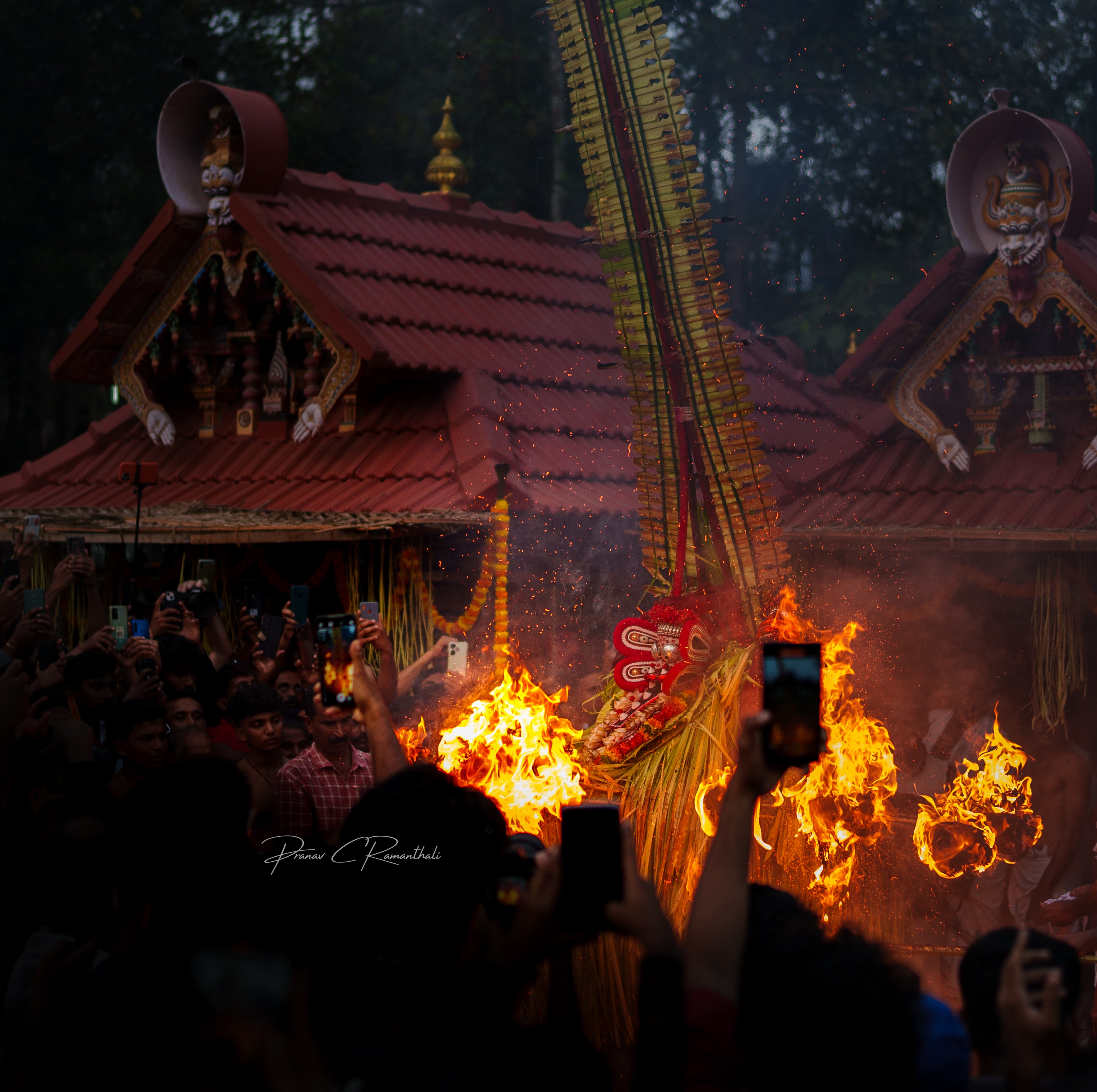 Theyyam ritual at temple premises with traditional architecture