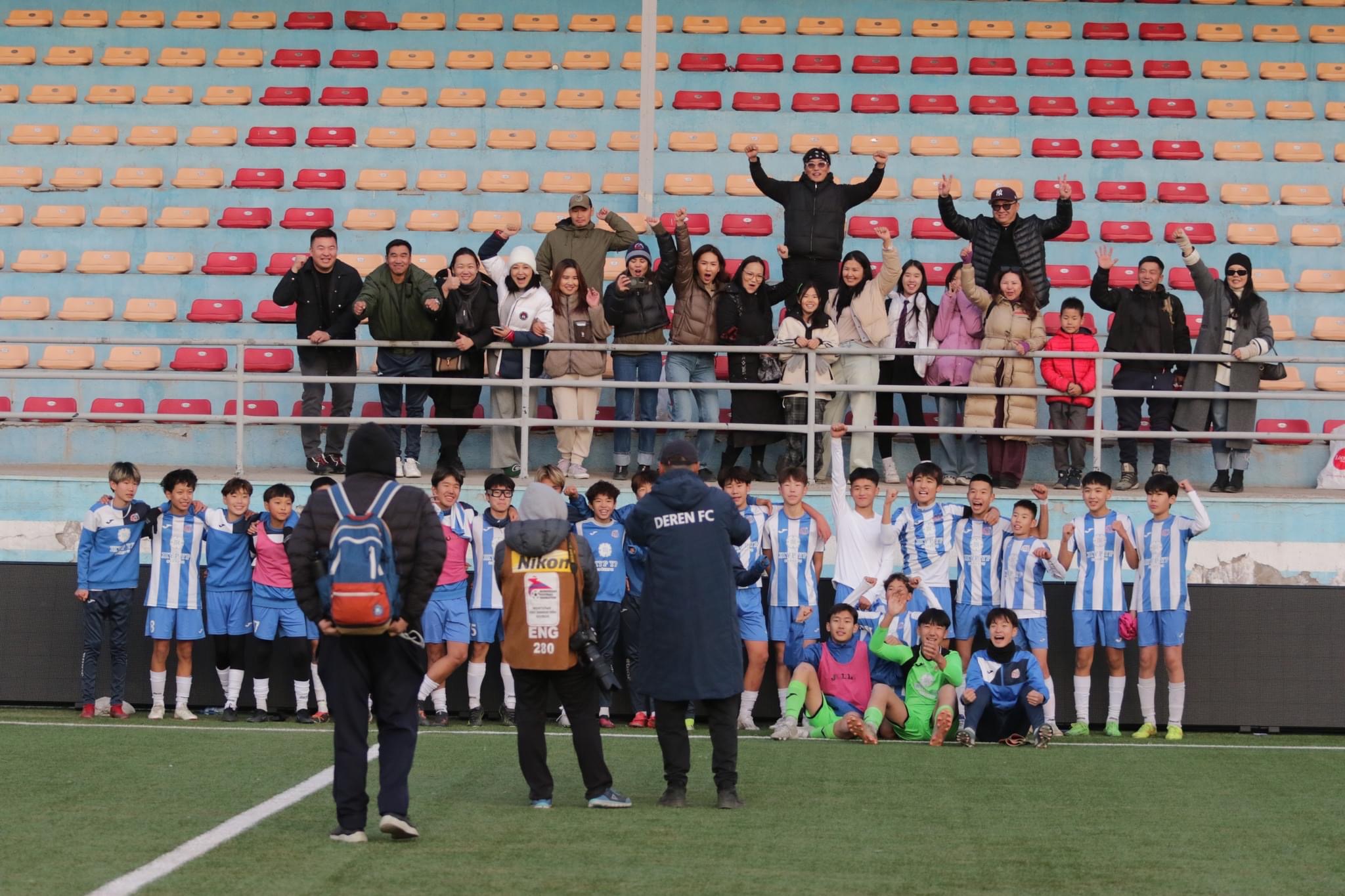 Team photo with fans celebrating
