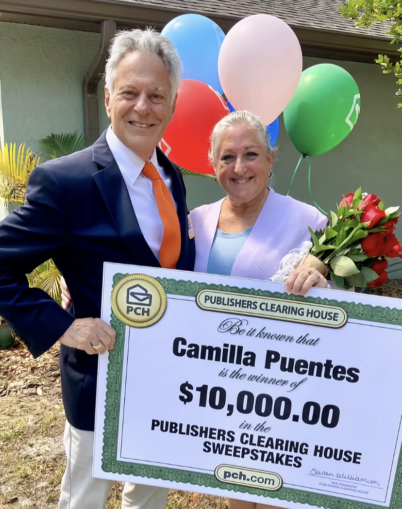 Camilla Puentes celebrating PCH sweepstakes win with colorful balloons and flowers