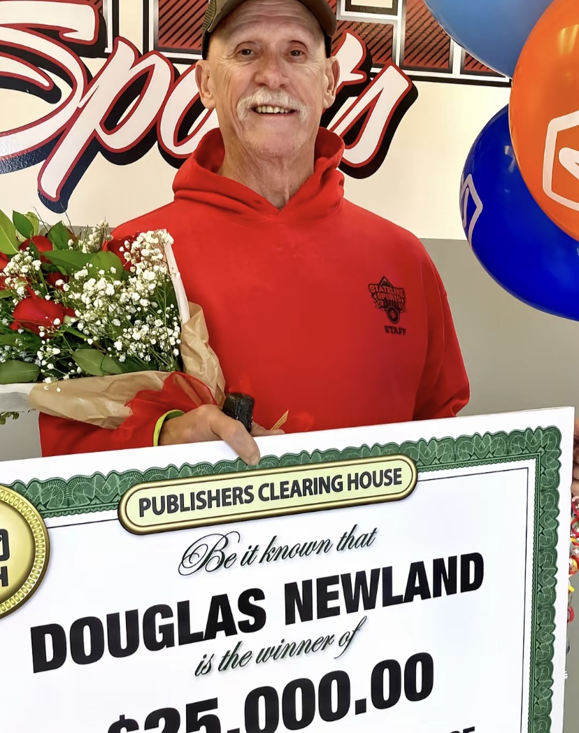 Douglas Newland with ceremonial PCH check displaying $25,000 prize