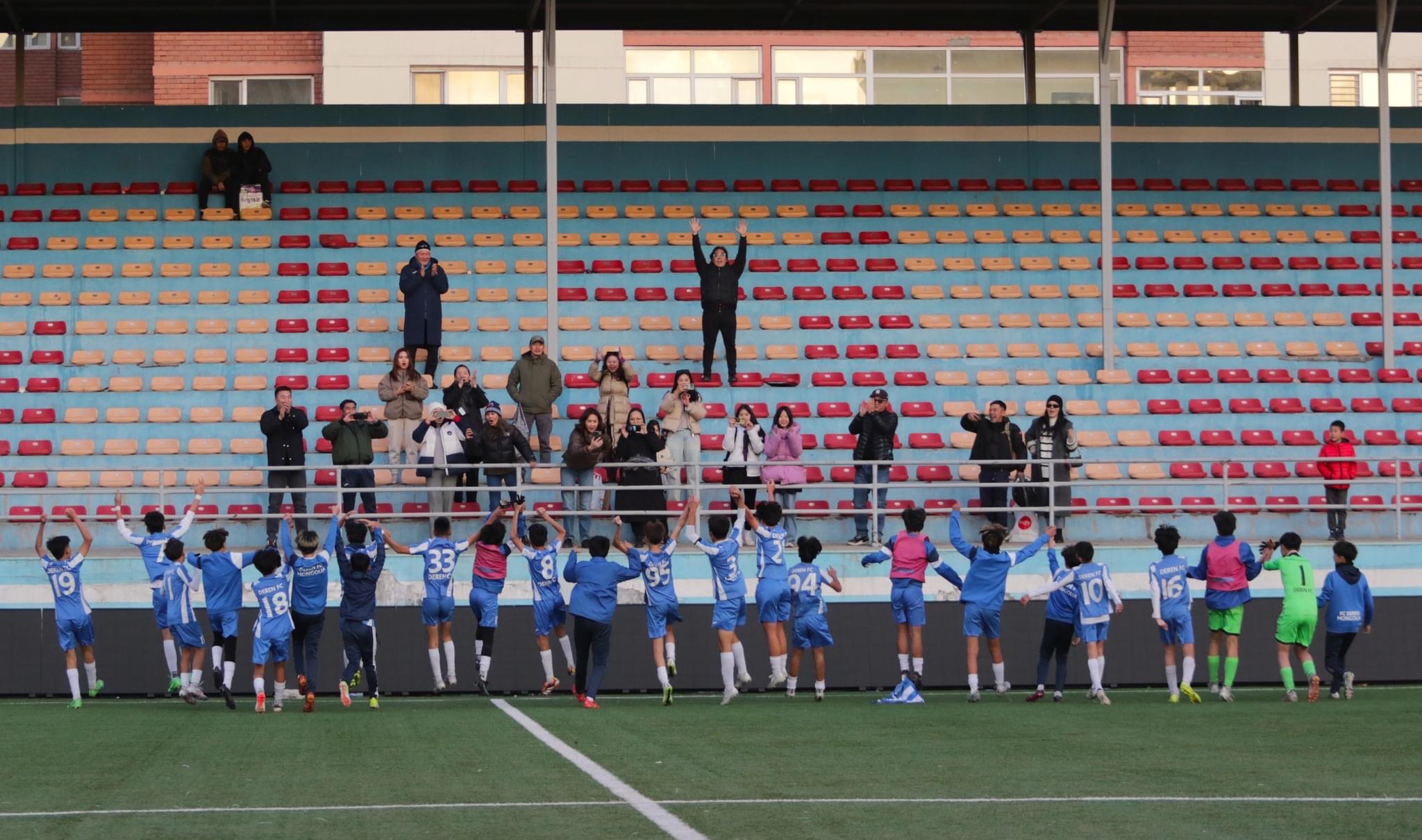 Team celebrating with fans in the stands
