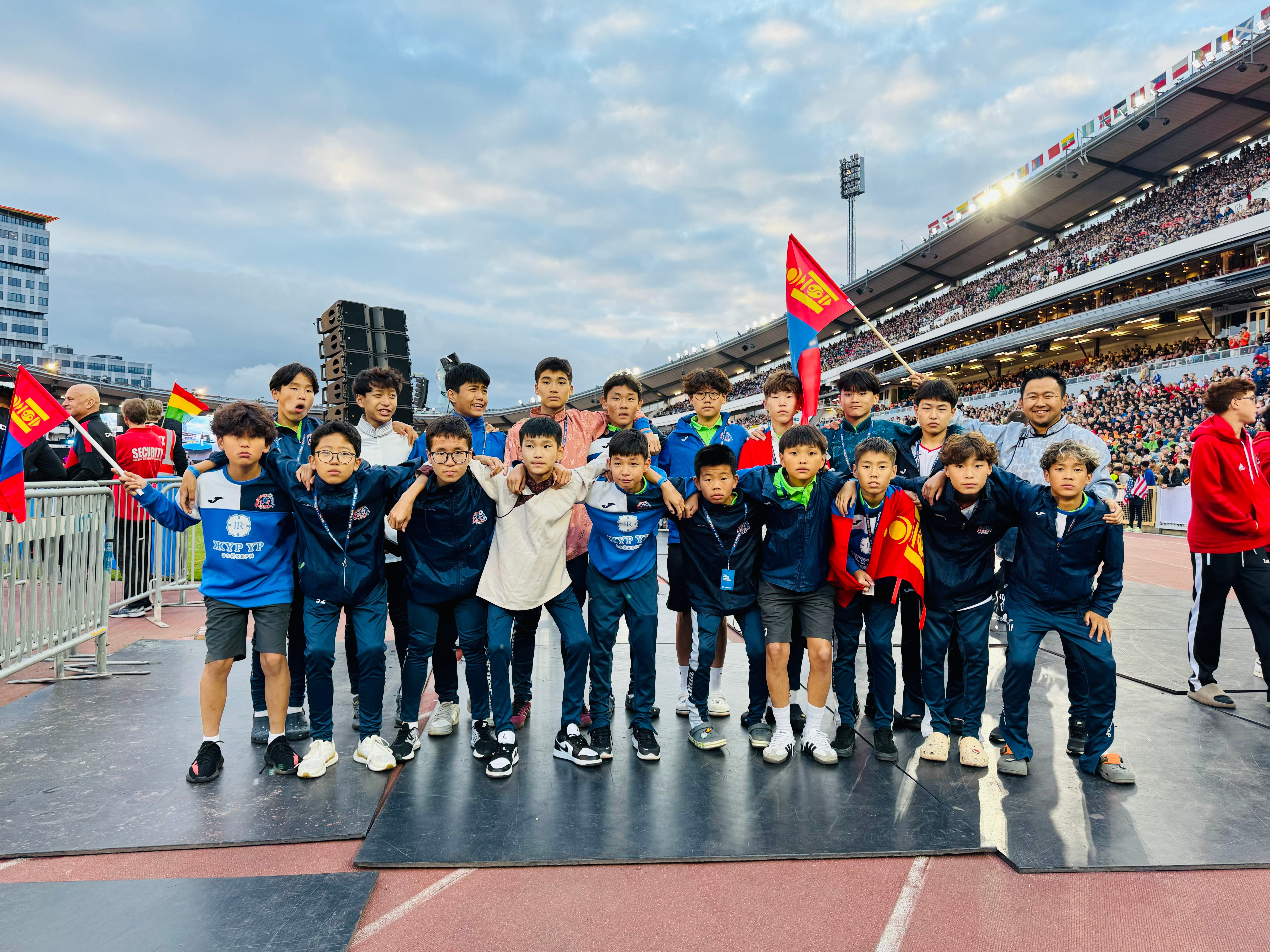 Team at Gothia Cup stadium with Mongolian flags