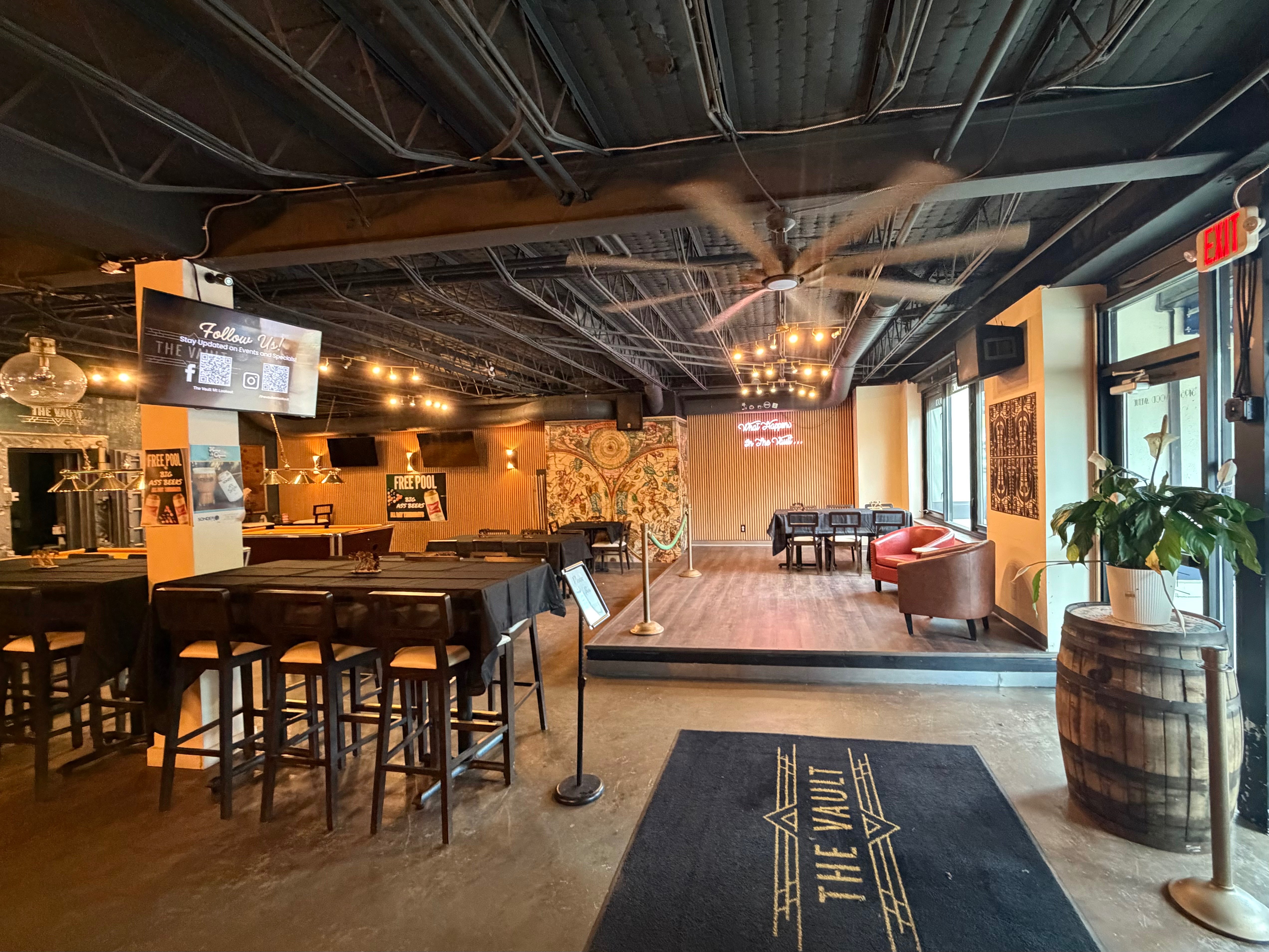 The Vault main floor from the entrance showing the stage, lounge area, and bar