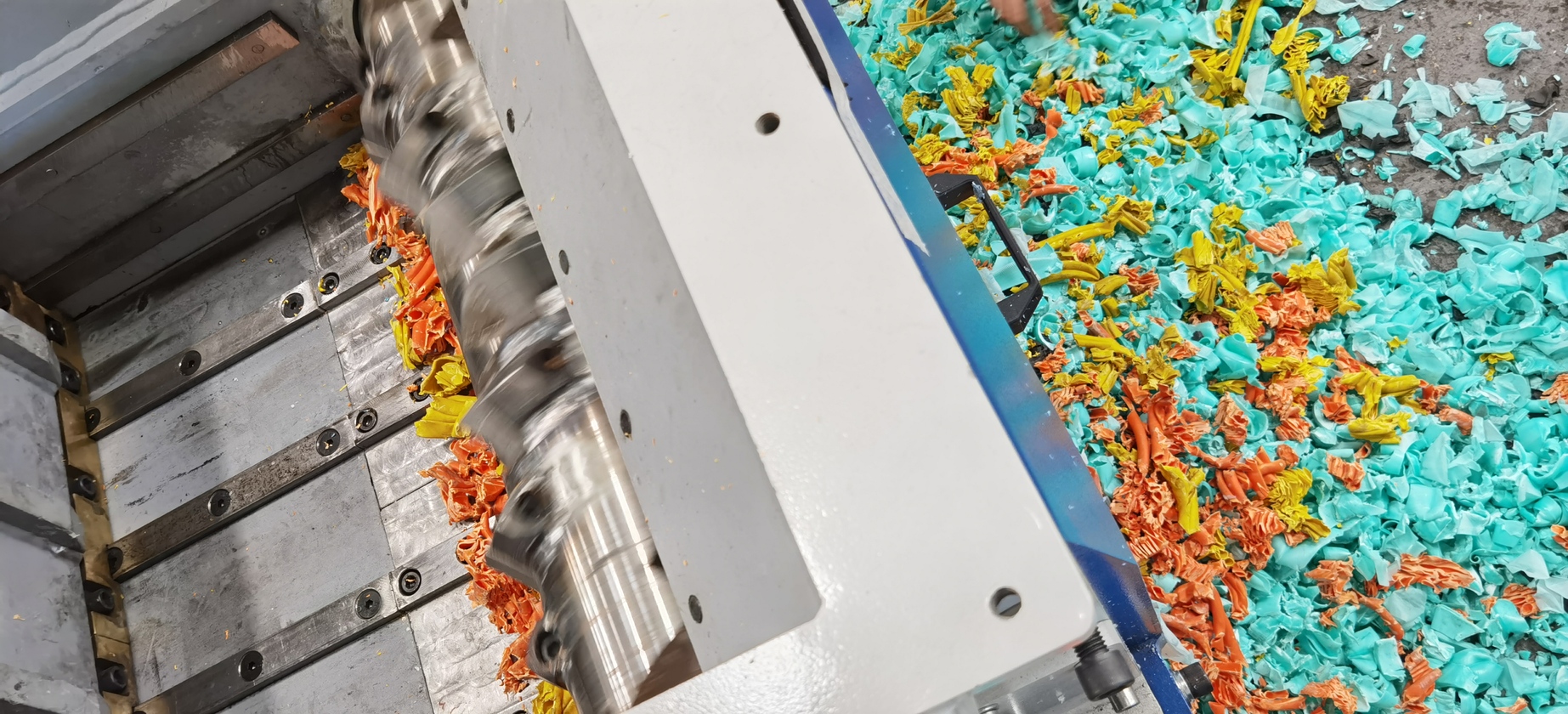 Industrial shredder processing colorful materials showing our destruction capabilities