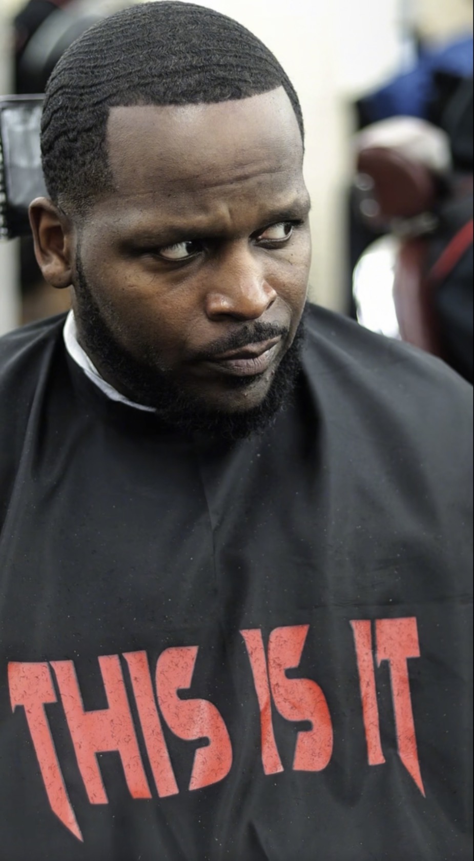 Clean waves haircut with cape showing This Is It branding
