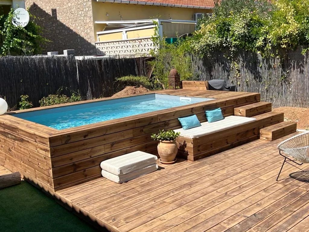 Wooden clad above-ground container pool with matching deck and bench