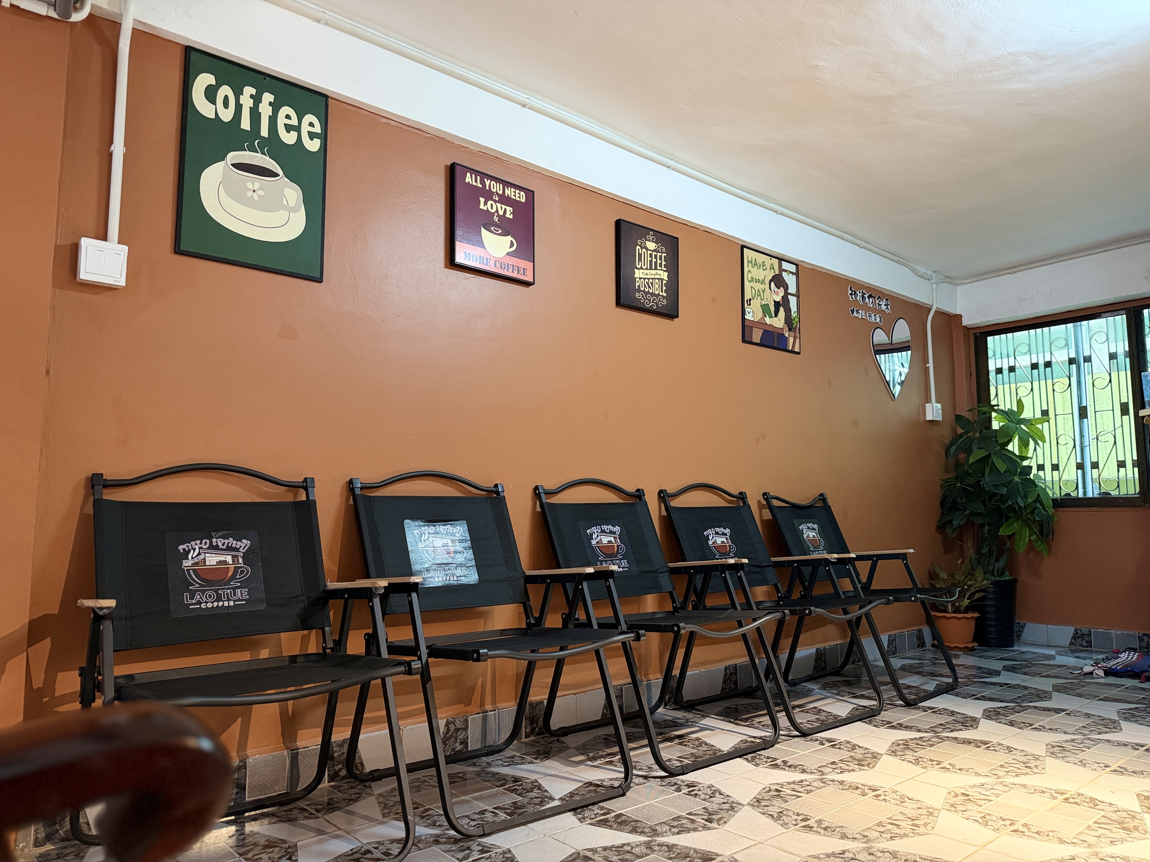 Seating area with branded chairs at Lao Tue Coffee