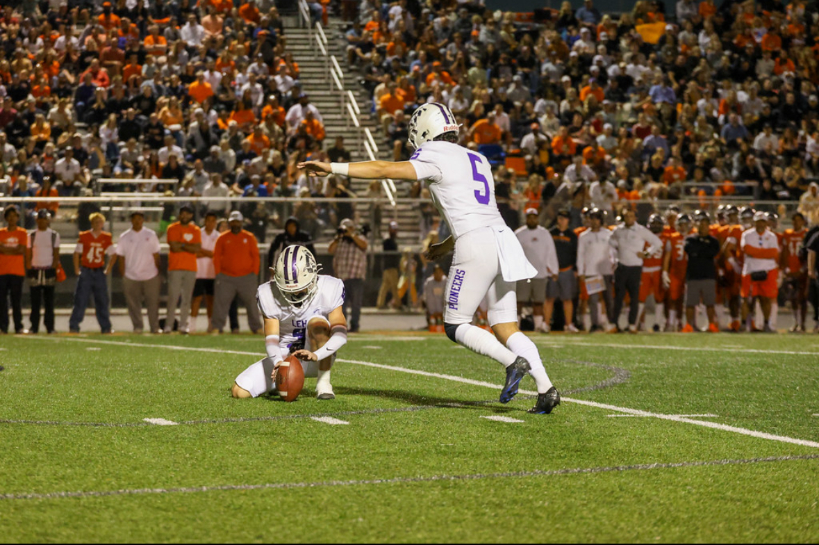 Field goal attempt with packed stadium at night game