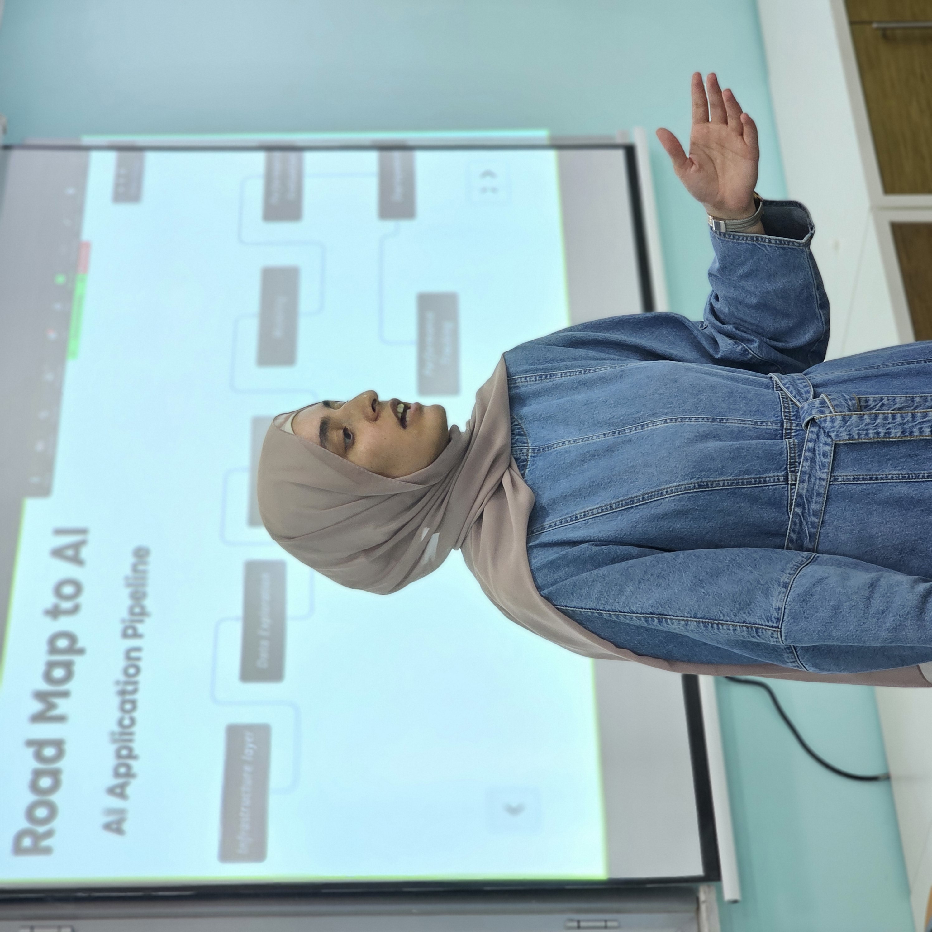 Tuqa presenting Road Map to AI - AI Application Pipeline in a classroom