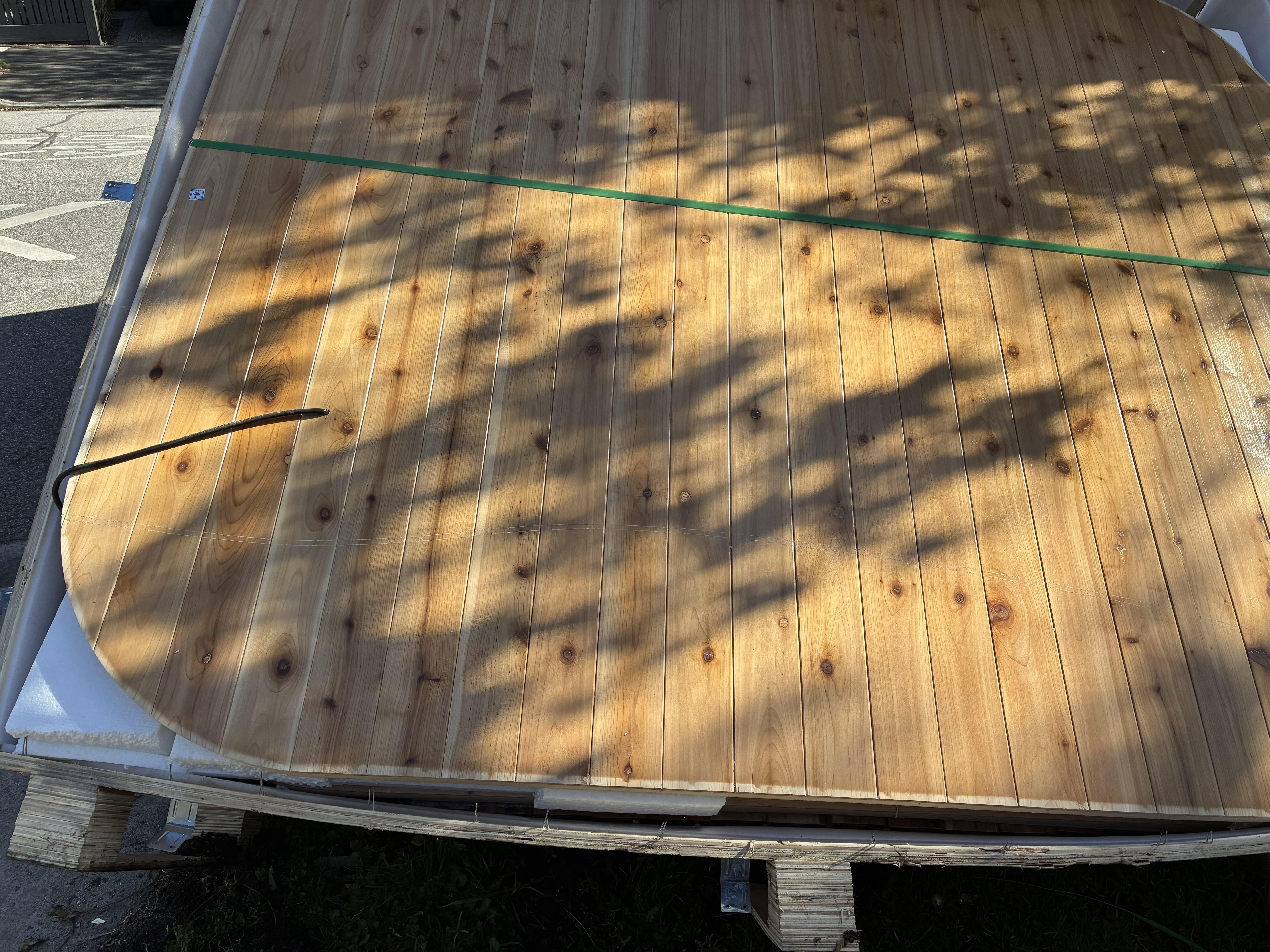 Close-up of the Canadian Red Cedar cladding panels on the pallet after arriving on site