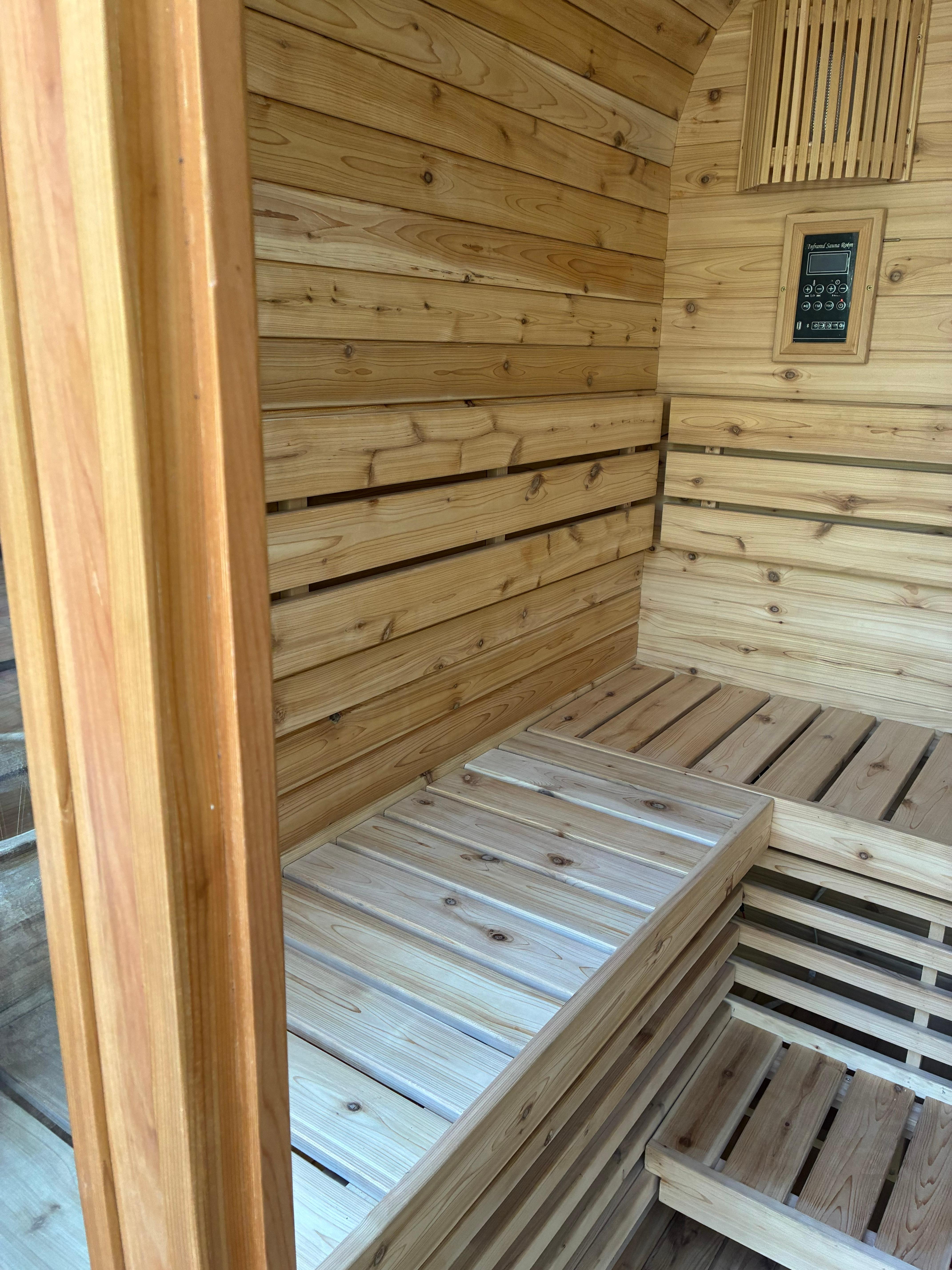 Finished cedar interior showing the corner bench layout, control panel and cedar door frame
