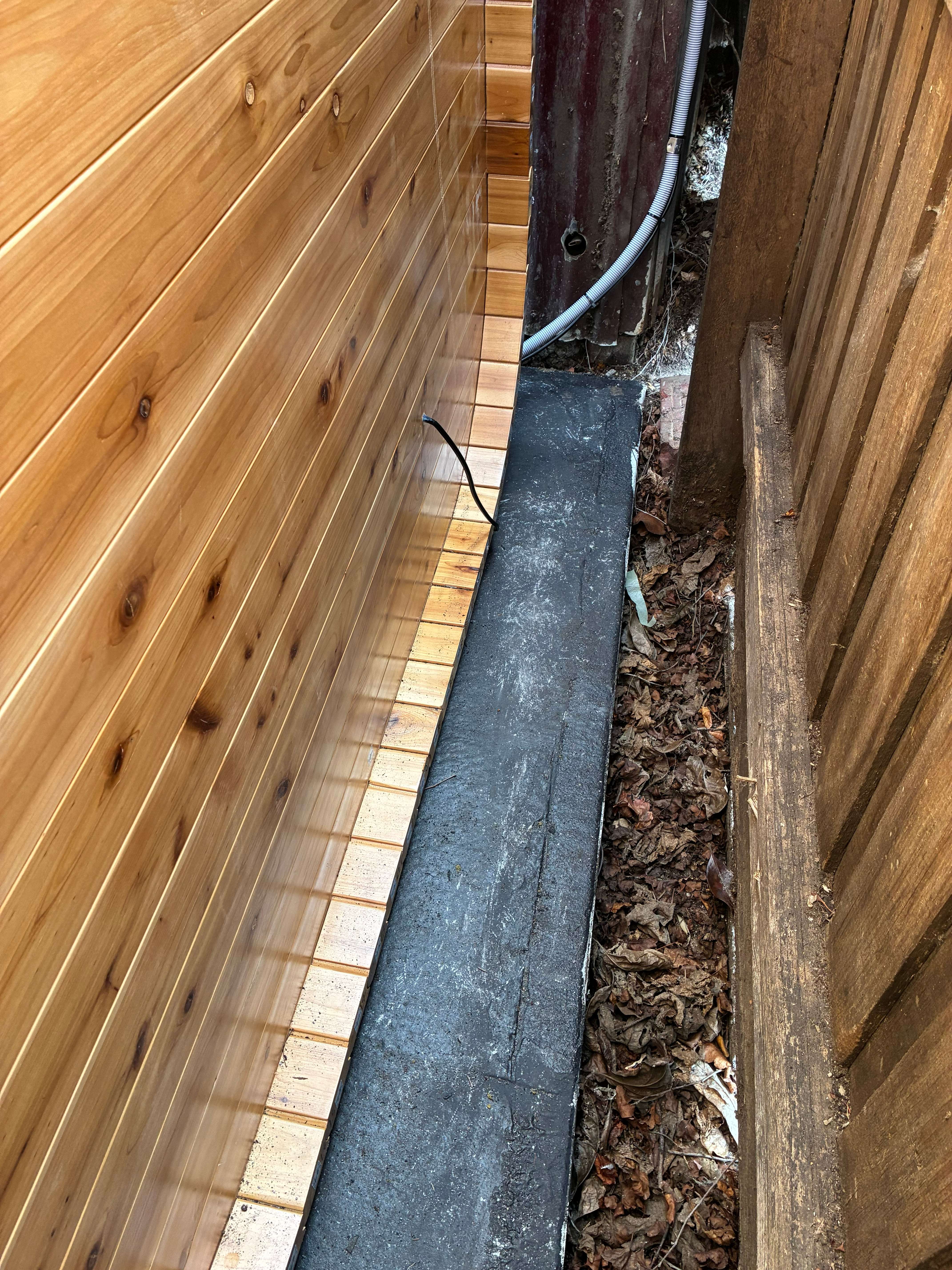 Installation detail showing the sealed base and electrical cabling routed along the fence line