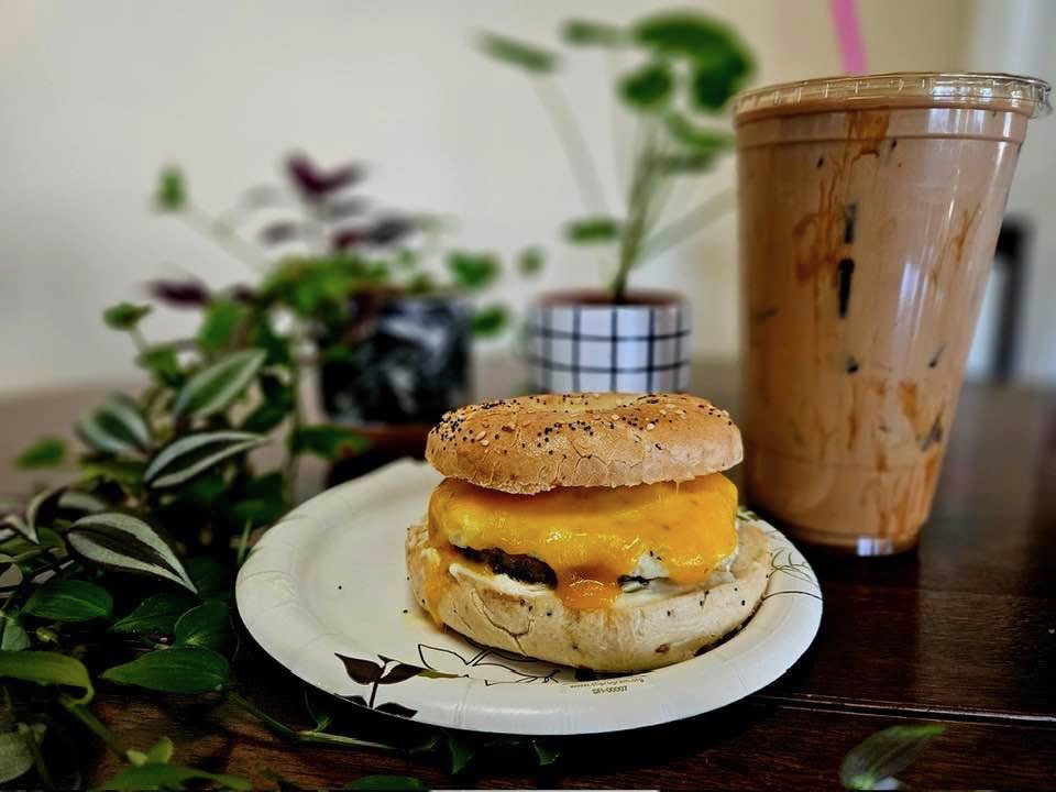 Breakfast sandwich on a bagel with iced coffee