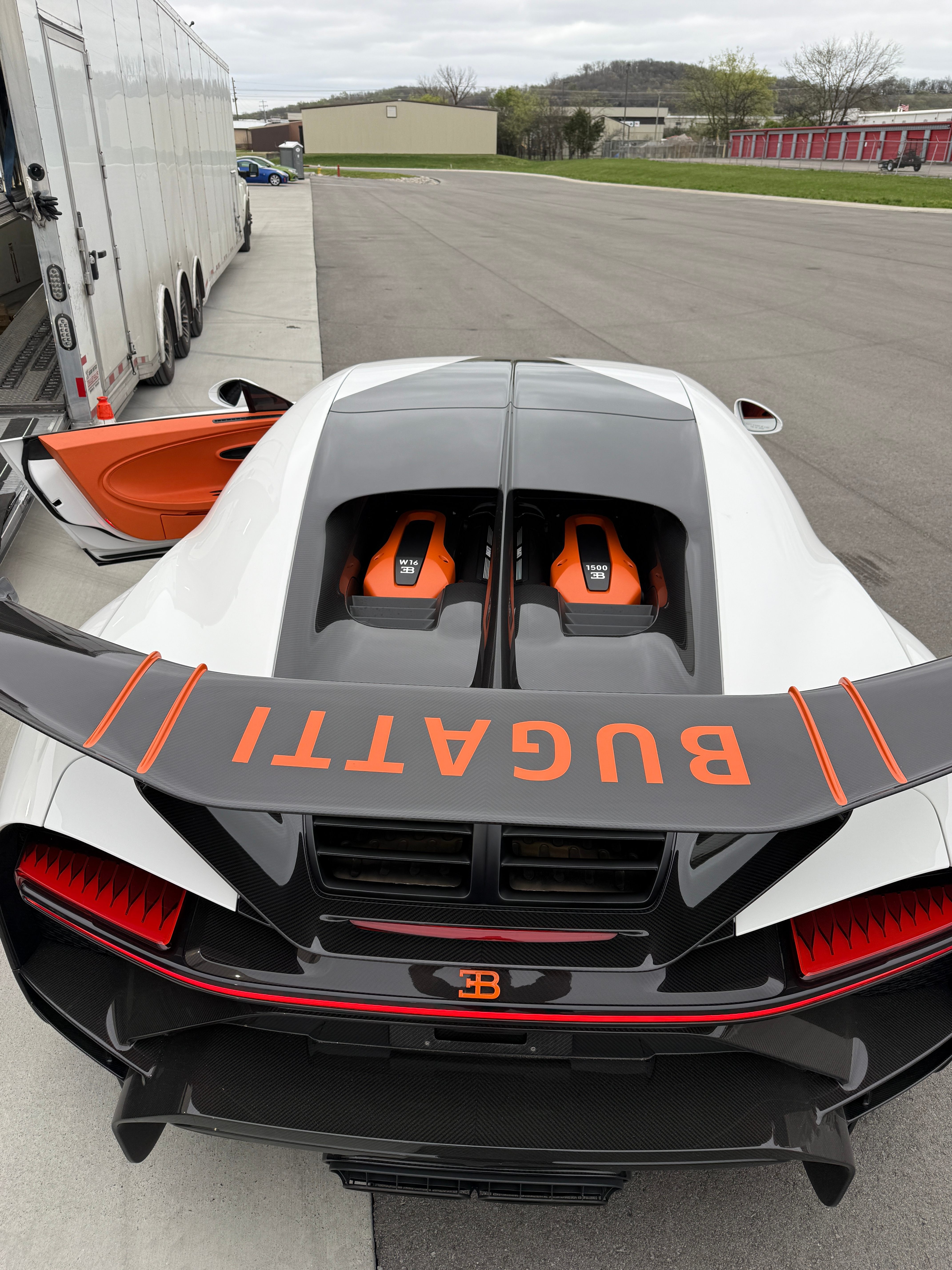 Bugatti Chiron Super Sport overhead showing W16 engine and BUGATTI wing lettering in orange