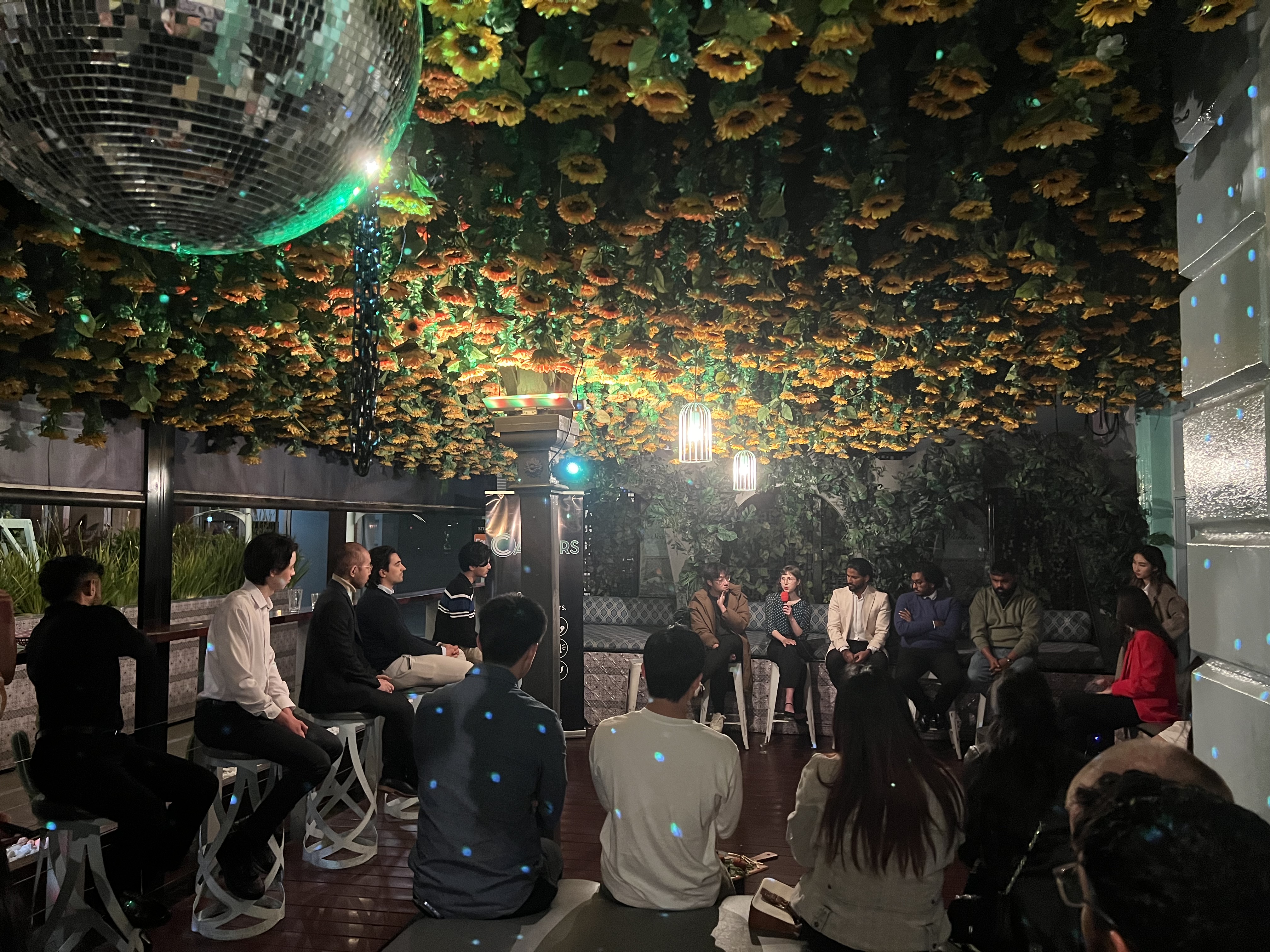 Career's Cocktail Night event with panel discussion in a venue decorated with sunflowers and a disco ball