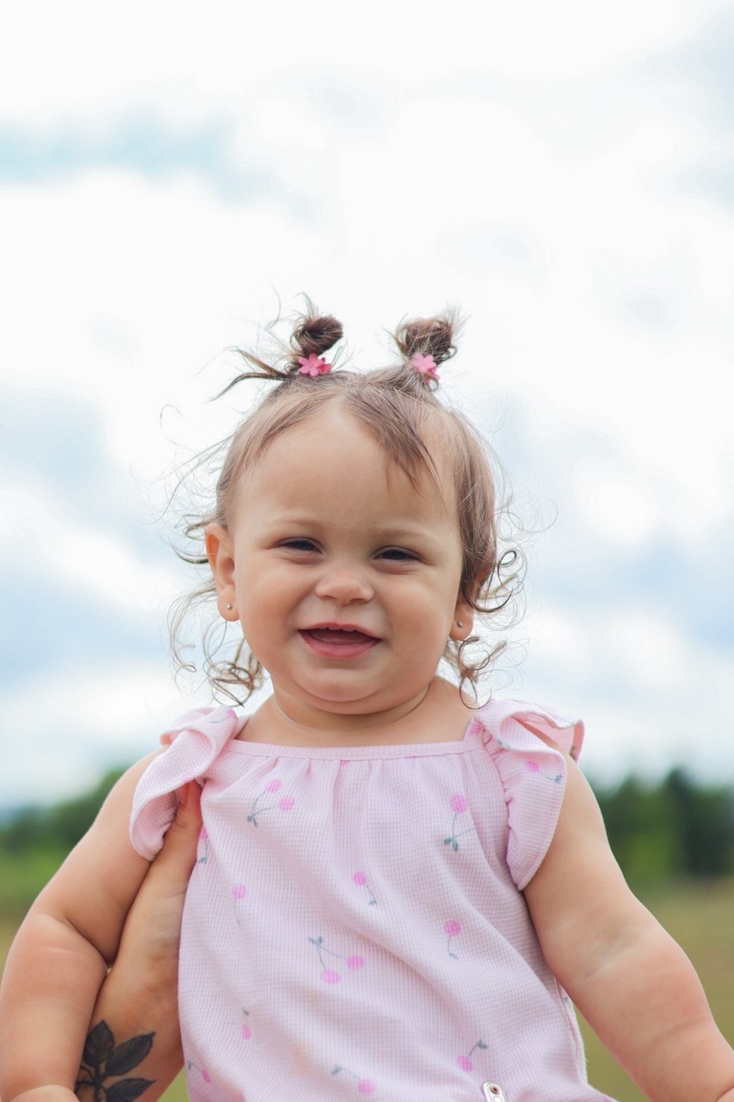 Smiling toddler with pigtails