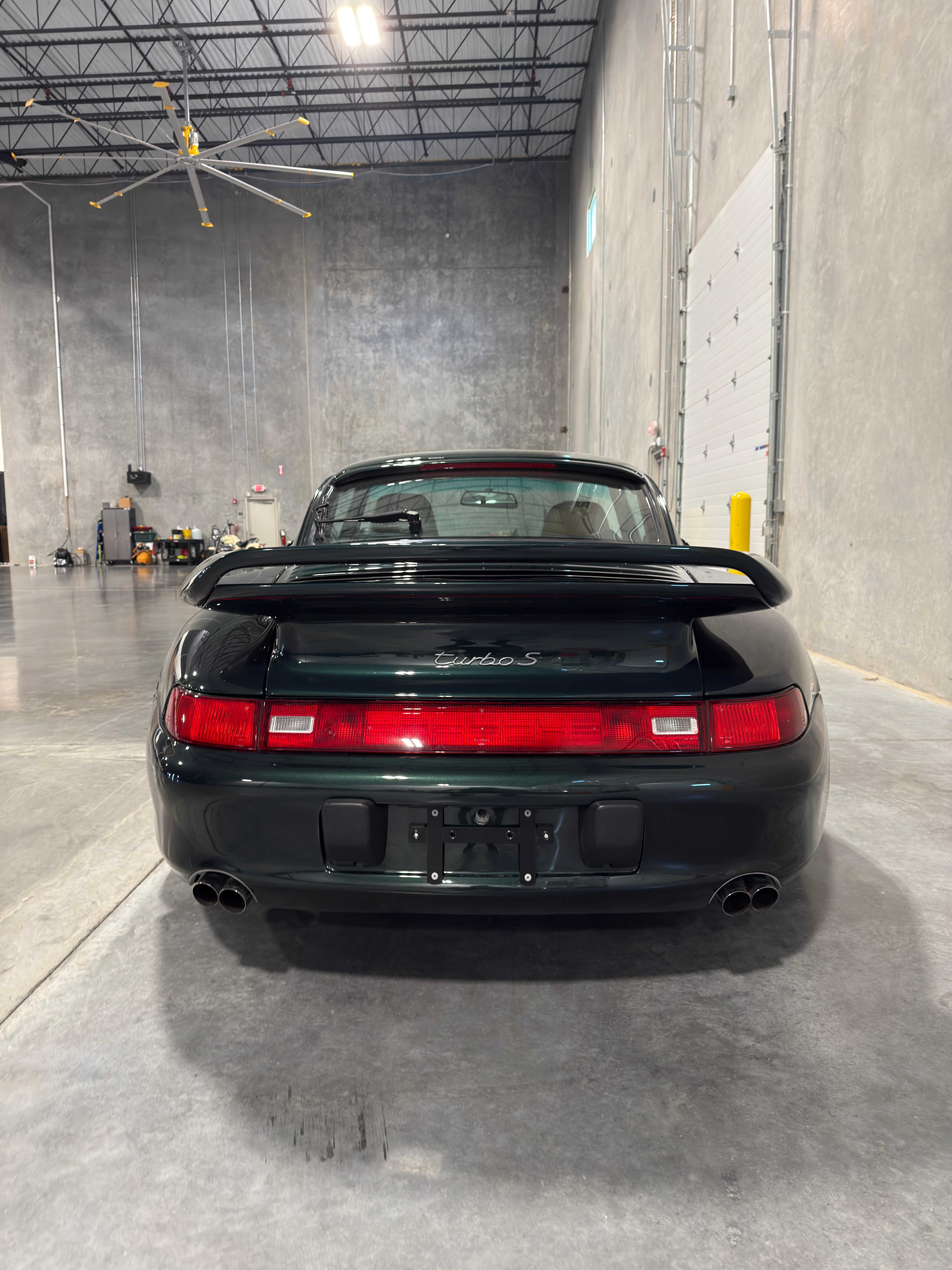 Porsche 993 Turbo S rear view in forest green with whale tail spoiler