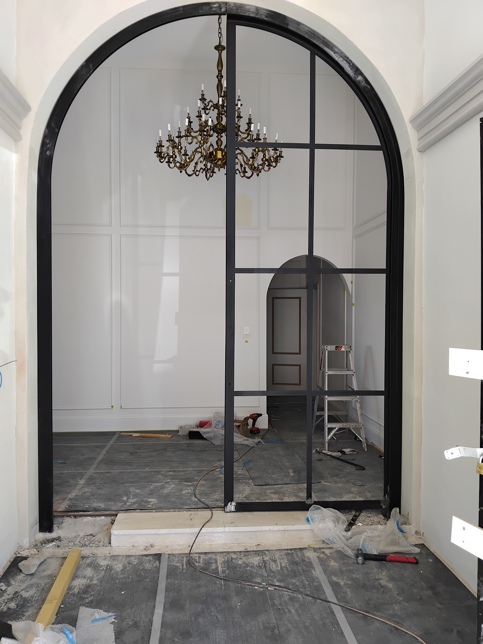 Arched steel-framed glass opening in an interior
