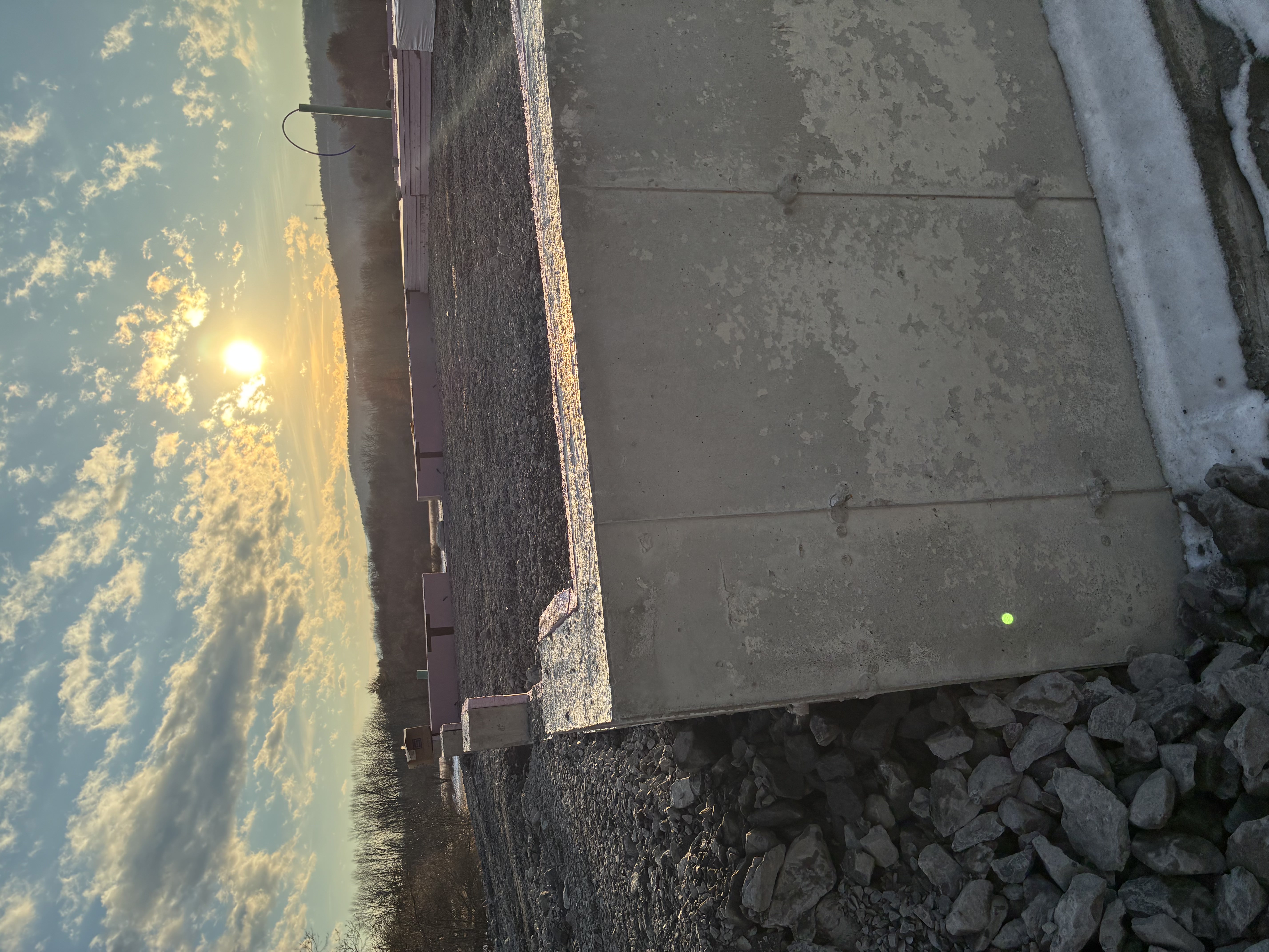 Poured concrete foundation wall at sunset