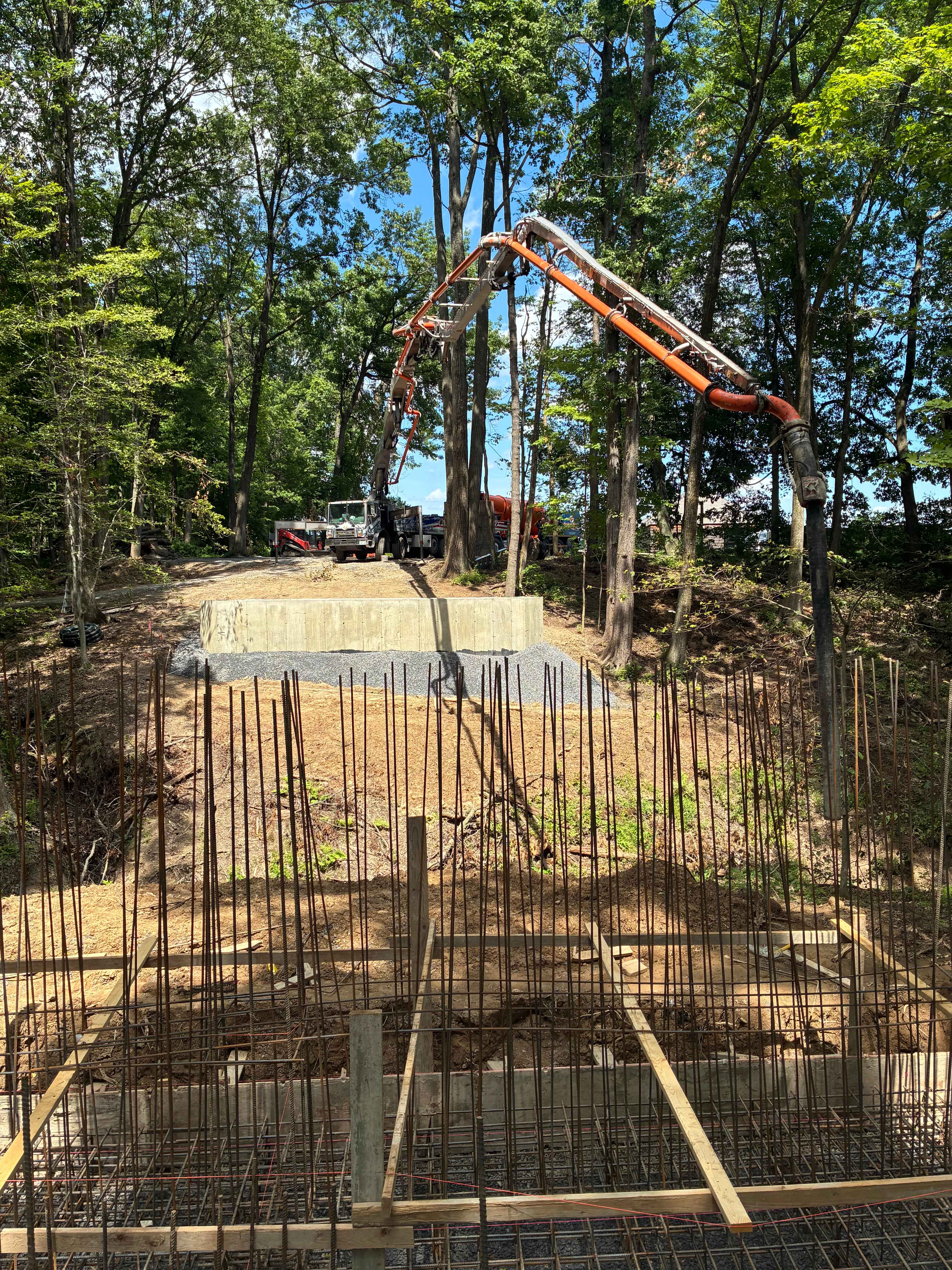 Concrete pump truck pouring foundation with dense rebar