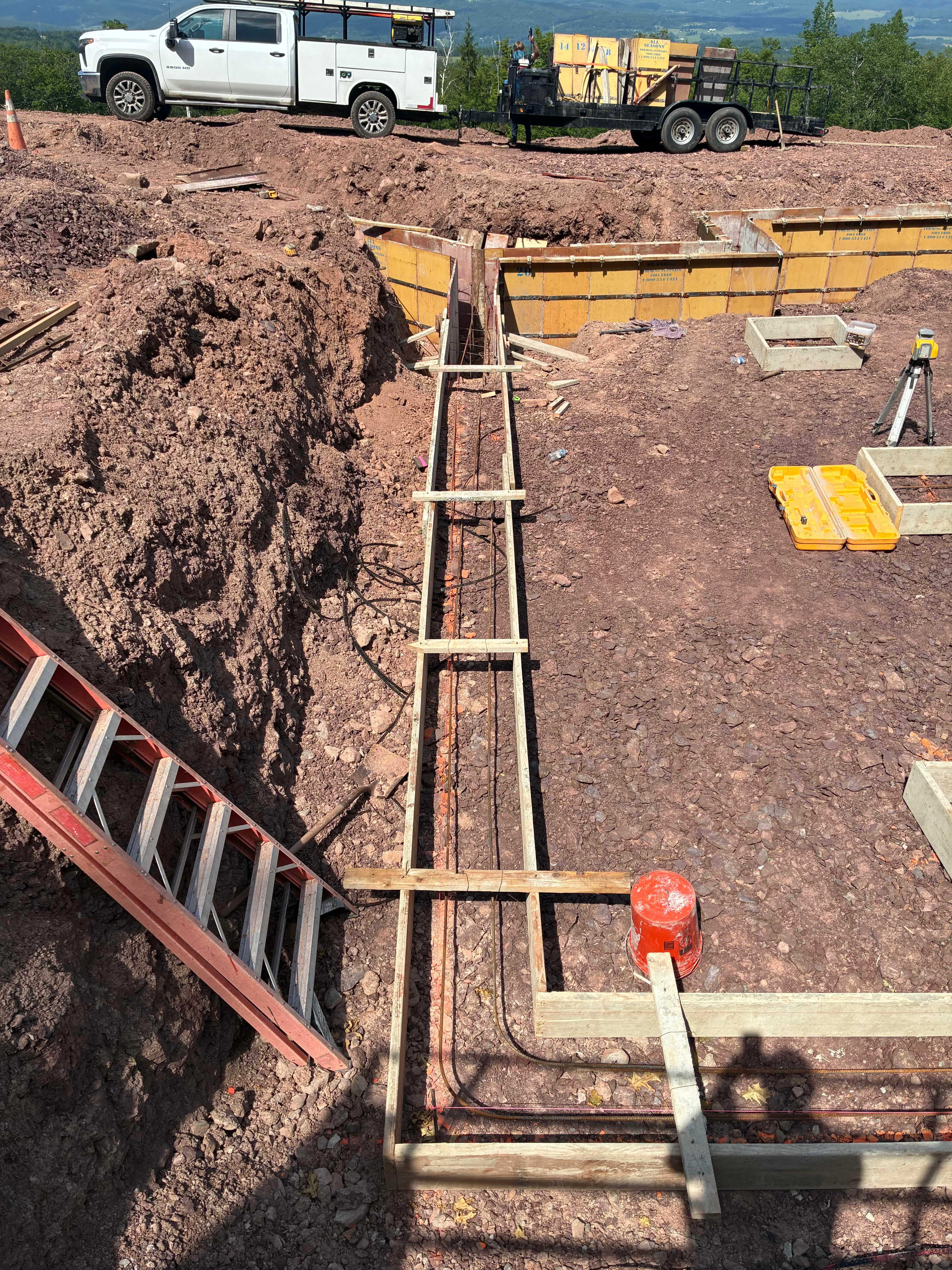 Footing forms with work truck on hilltop site