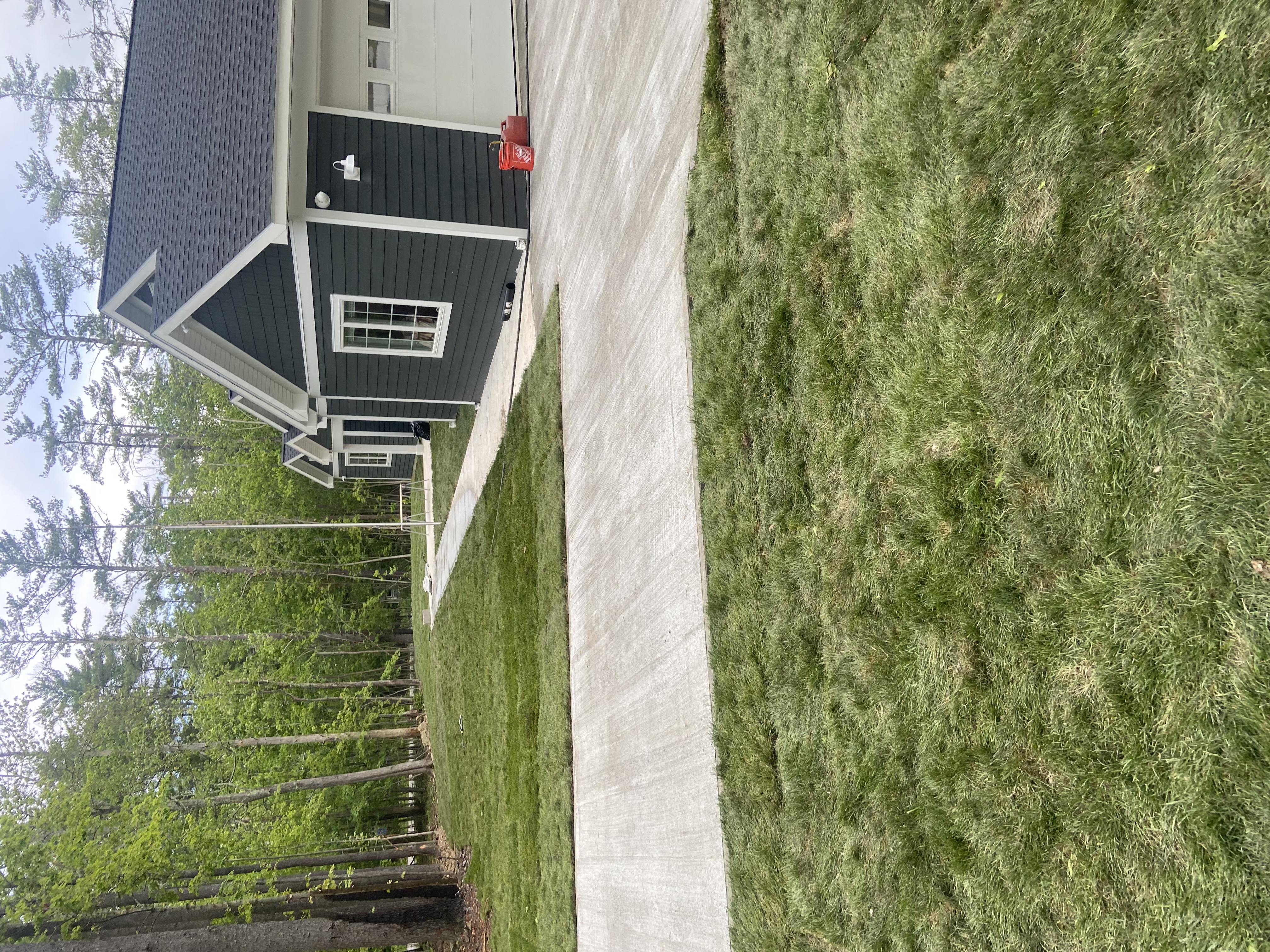 Finished driveway and walkway at modern gray home