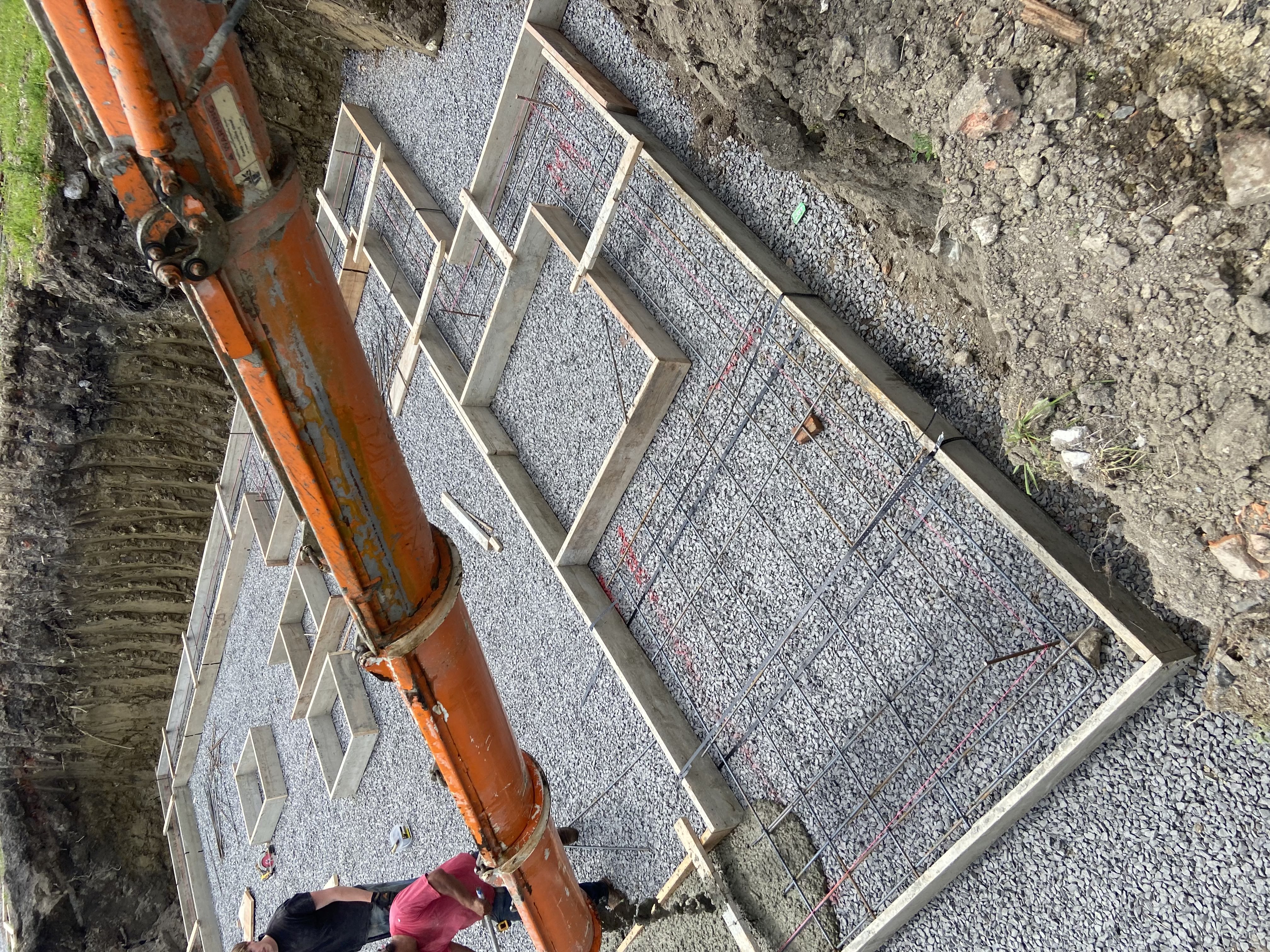 Footing pour in progress with pump truck
