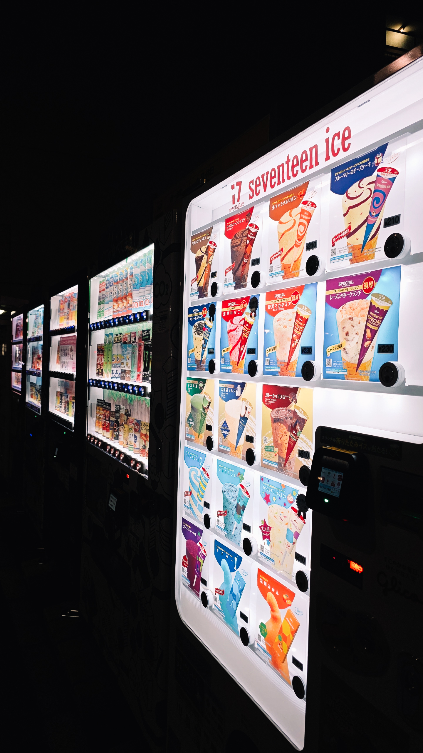 Illuminated ice cream vending machines at night