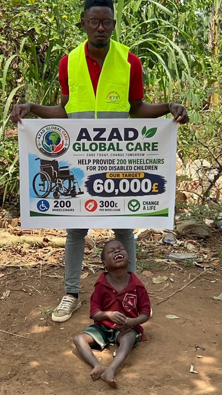 Volunteer with wheelchair campaign banner and child