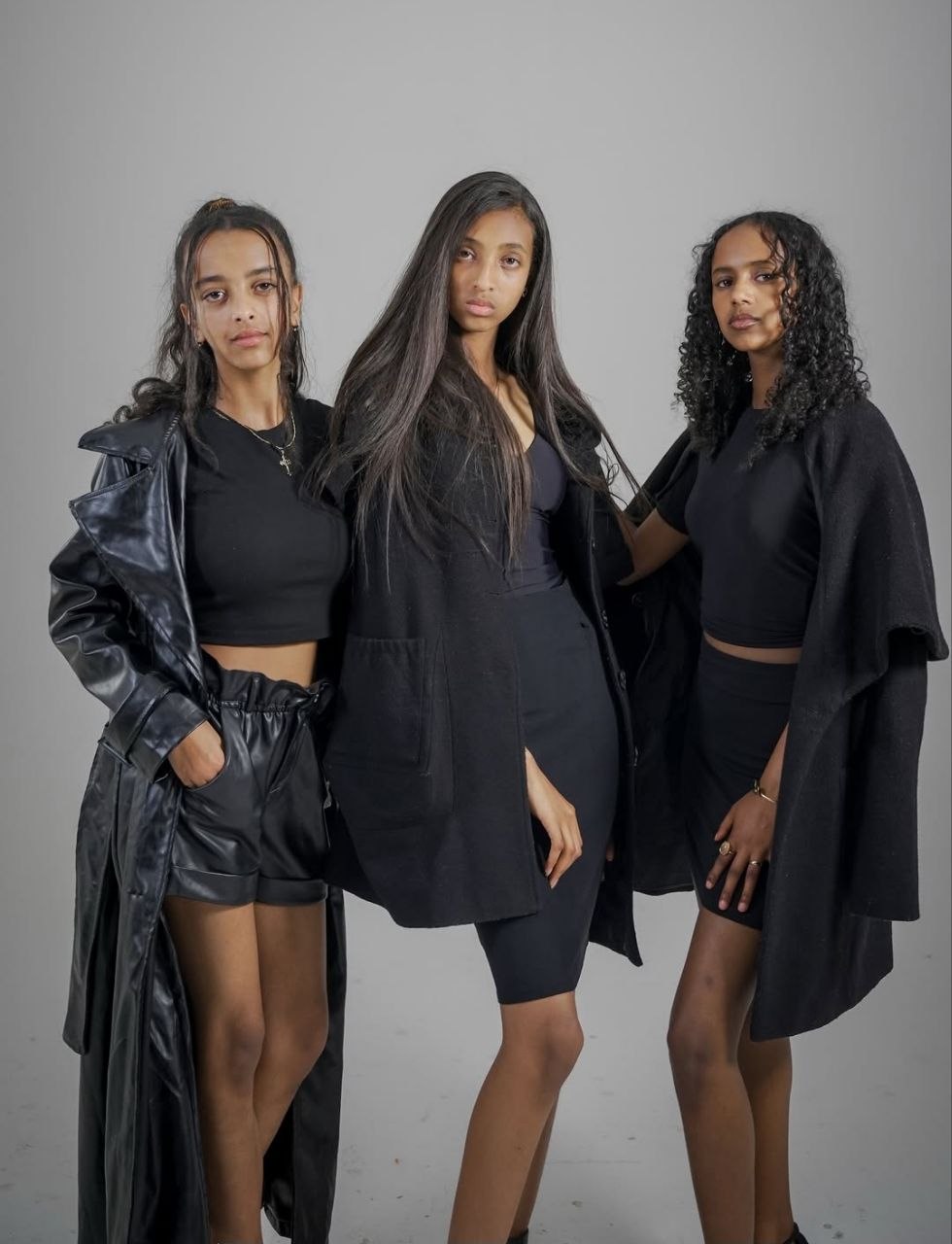 Three models styled in black