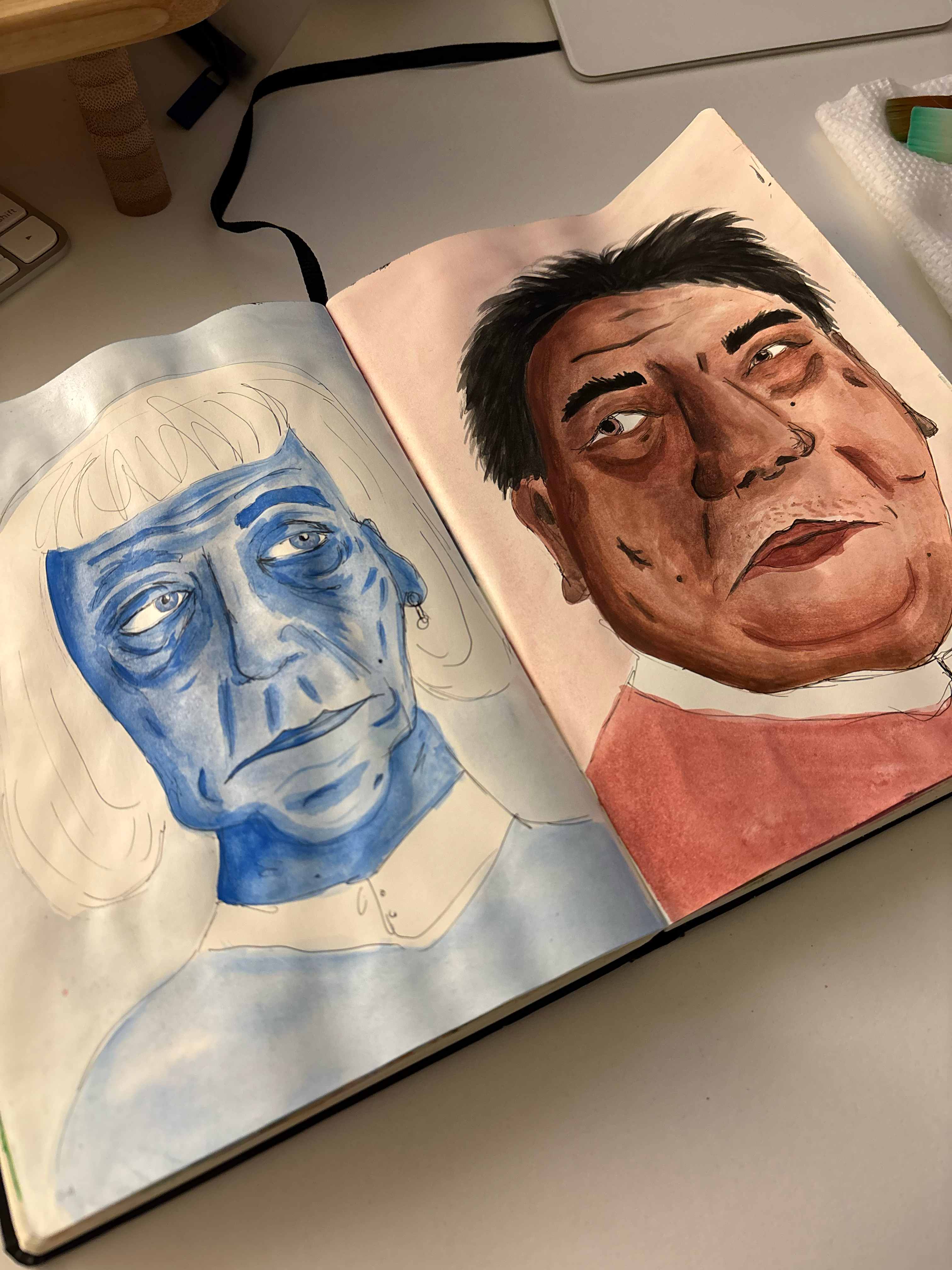 Sketchbook spread with two portraits